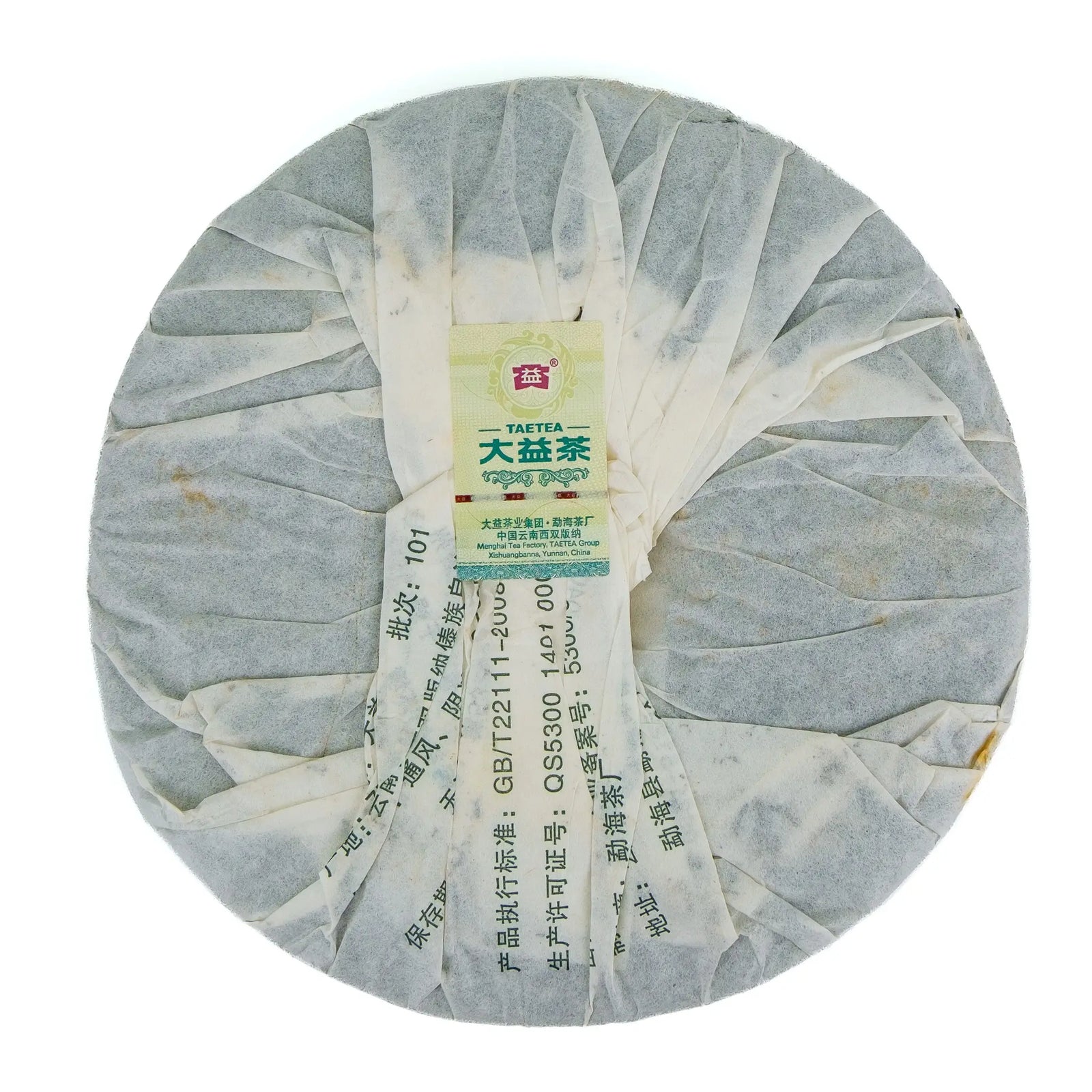 Back of the 2011 Dayi 7542 raw puerh cake, folded paper wrapper with a small Taetea label and the printed batch number 101