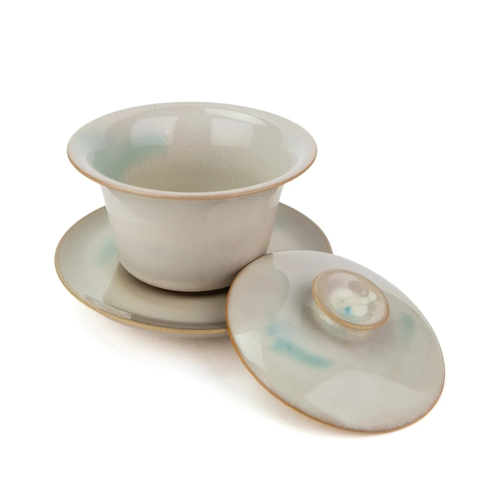 An overhead view of a white gaiwan for gong fu tea with the lid off.