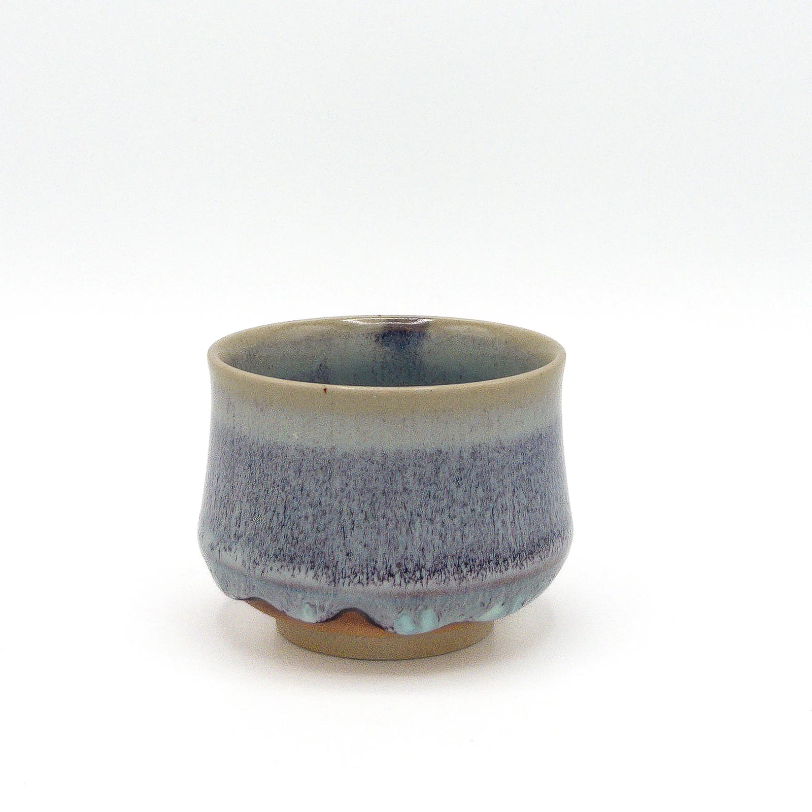 Ceramic cup with blue and gray speckled design on a white background