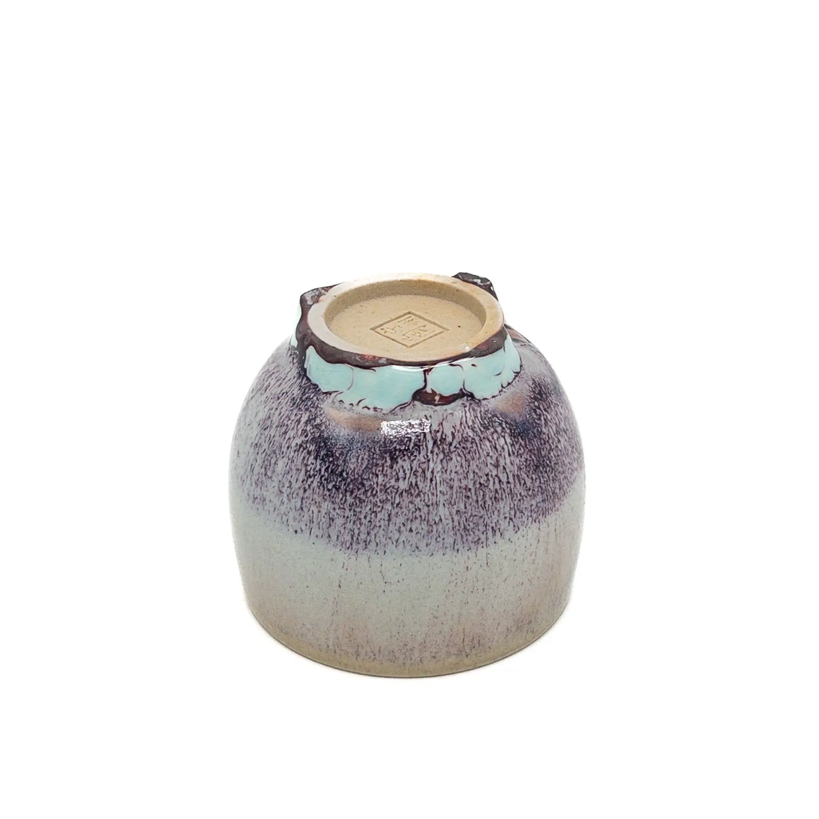 Ceramic cup with speckled design on a white background