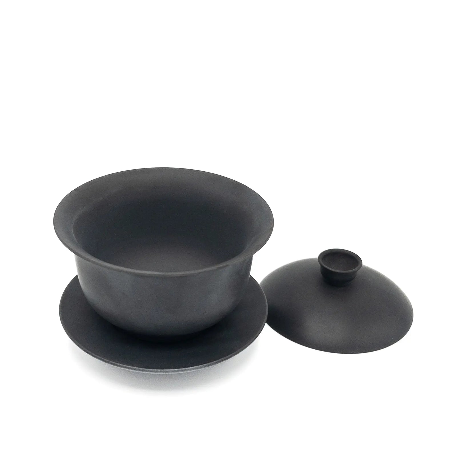 Black gaiwan with lid off on a white background