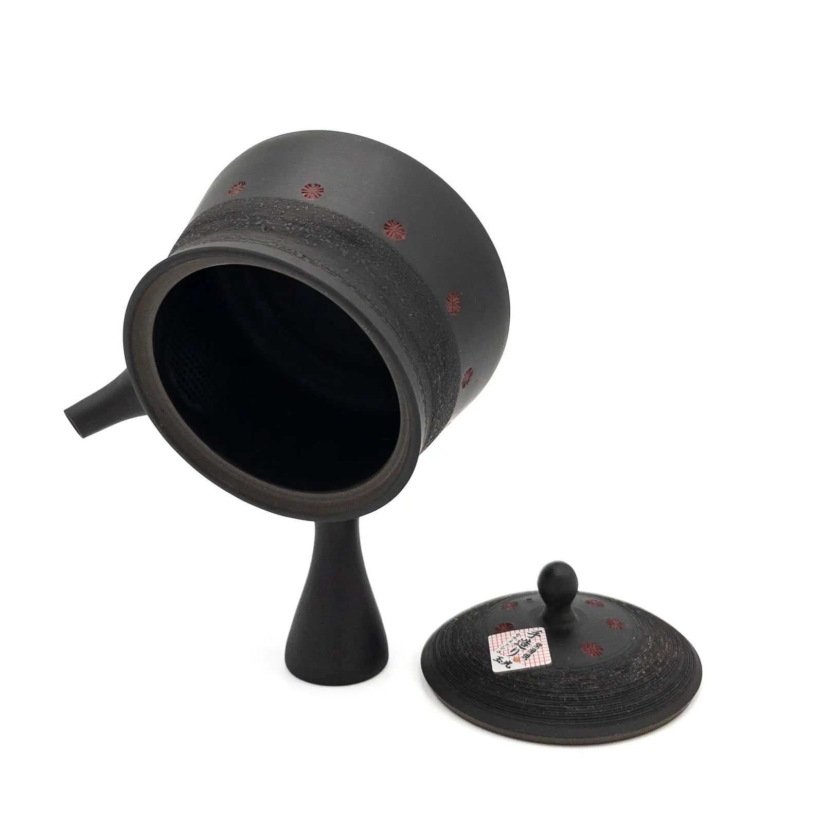 Black ceramic teapot with lid on a white background