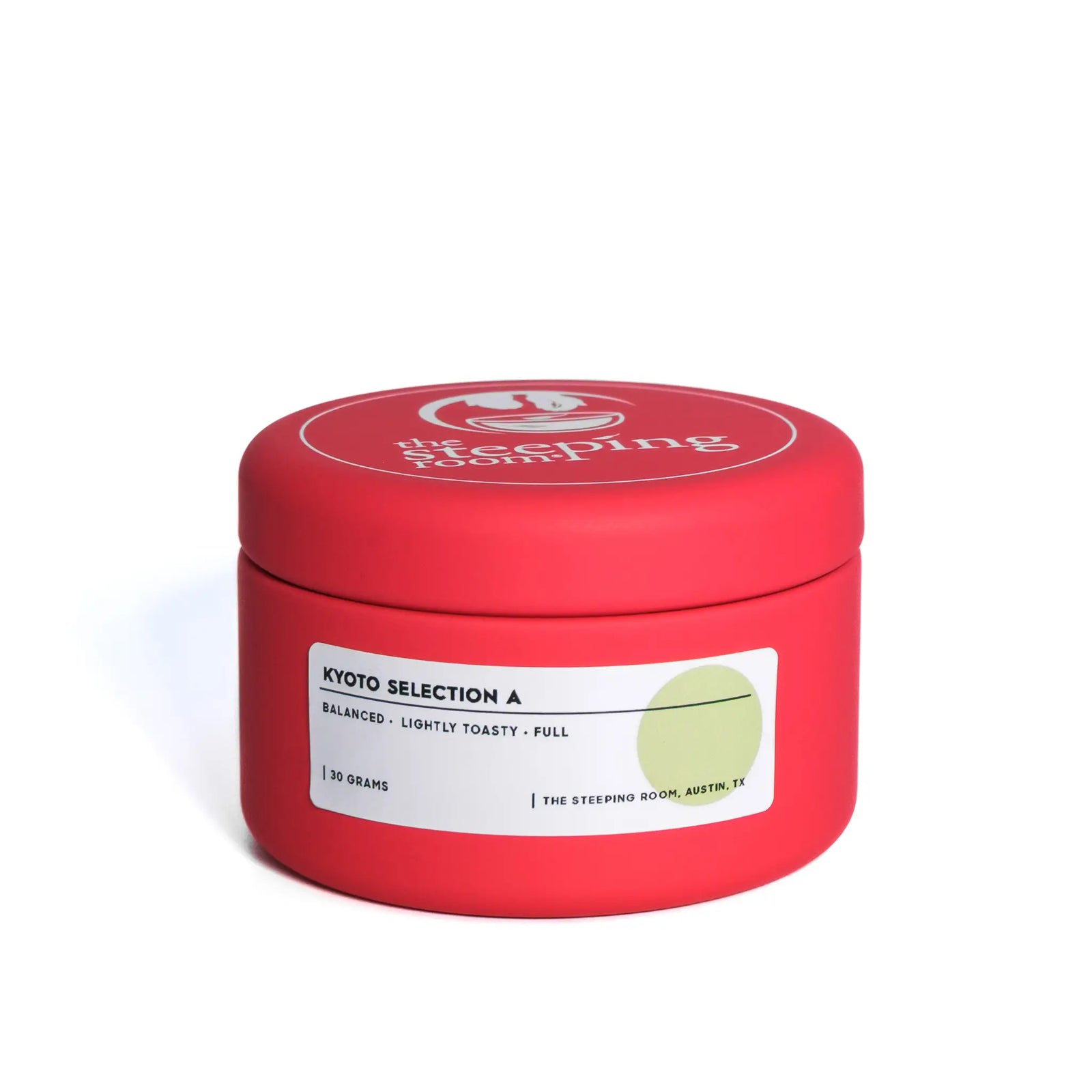 Red cylindrical matcha container with a white label on a white background