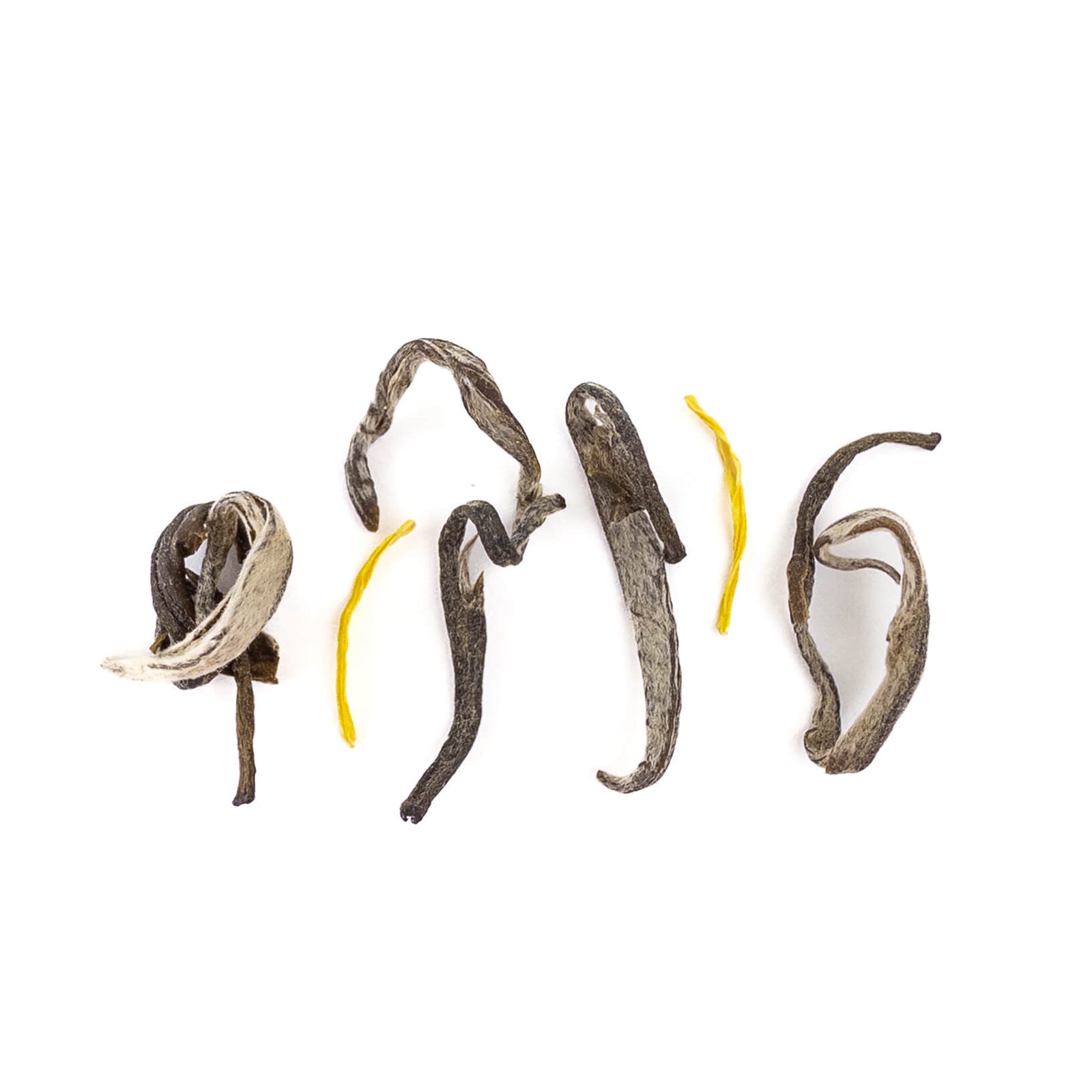 Dried green tea leaves and lotus stamens on a white background