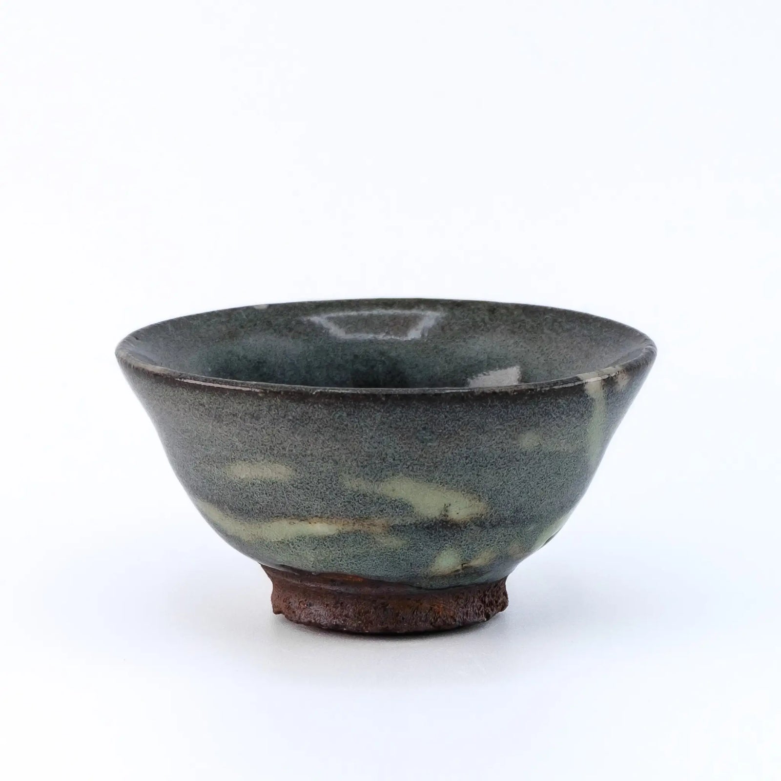 Ceramic cup with a speckled glaze on a white background