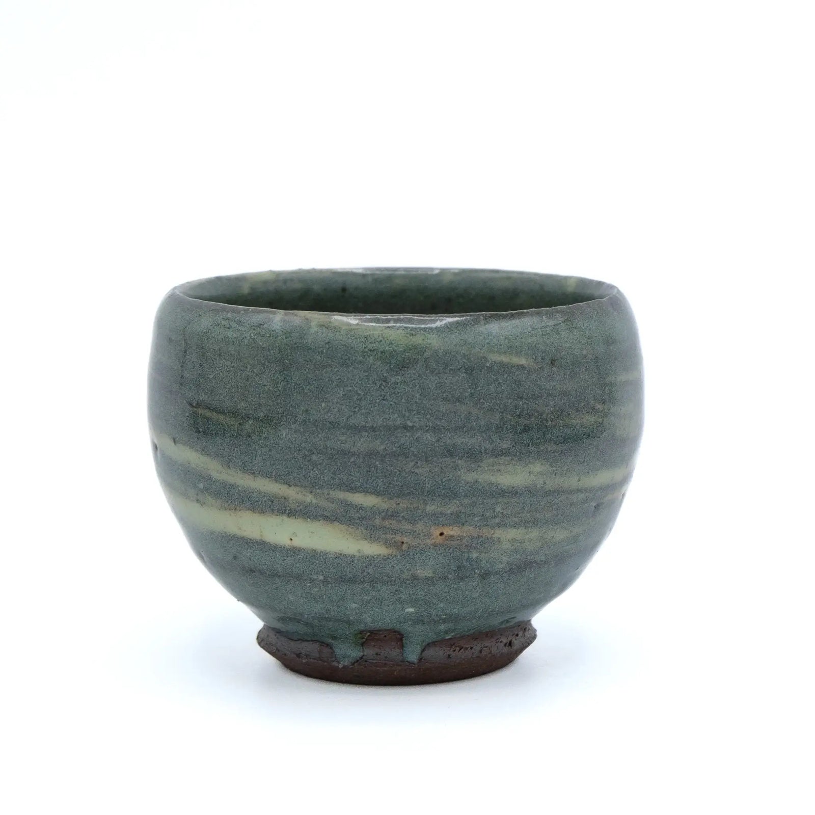 Greenish ceramic cup with striped pattern on a white background