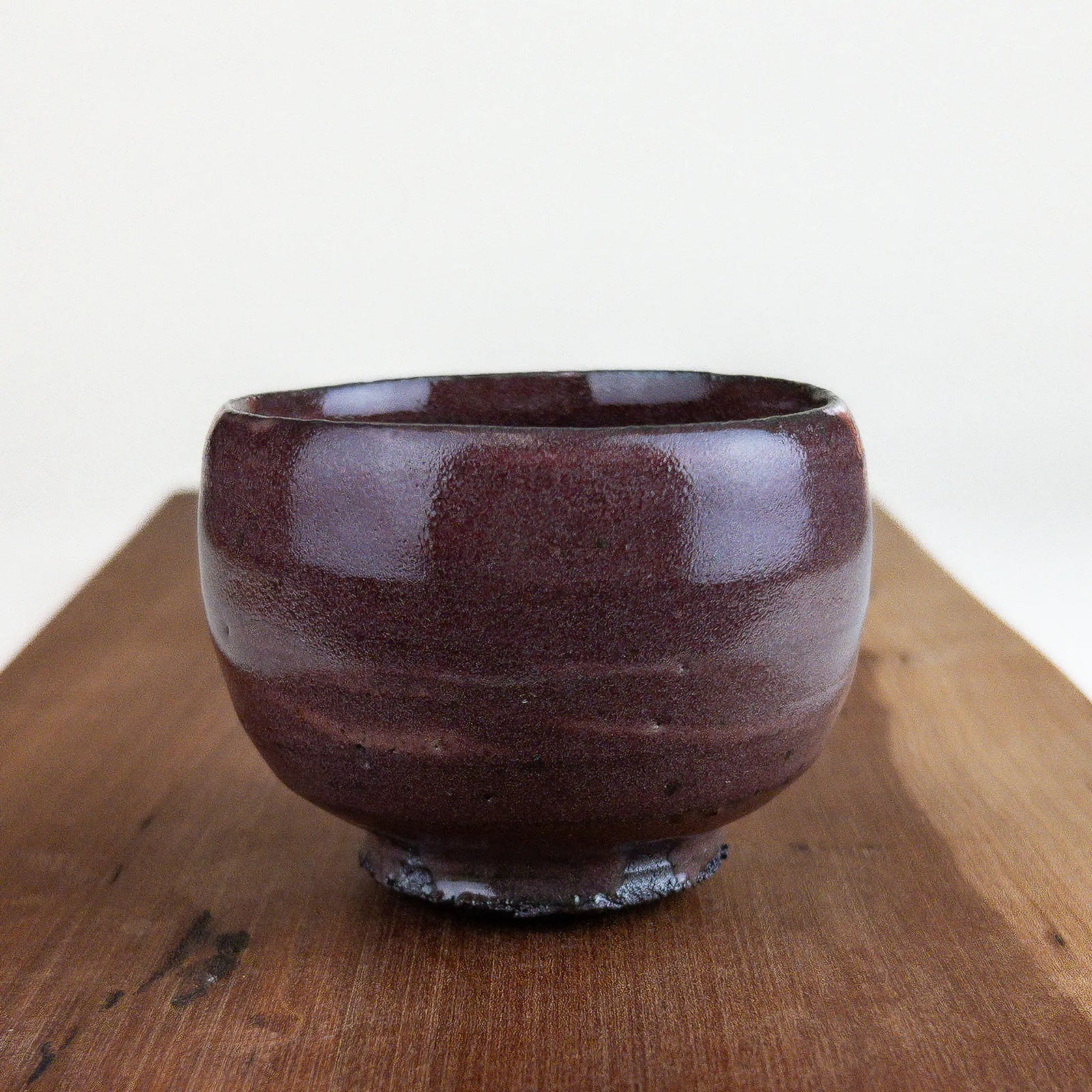 Ceramic cup on a wooden surface with a white background