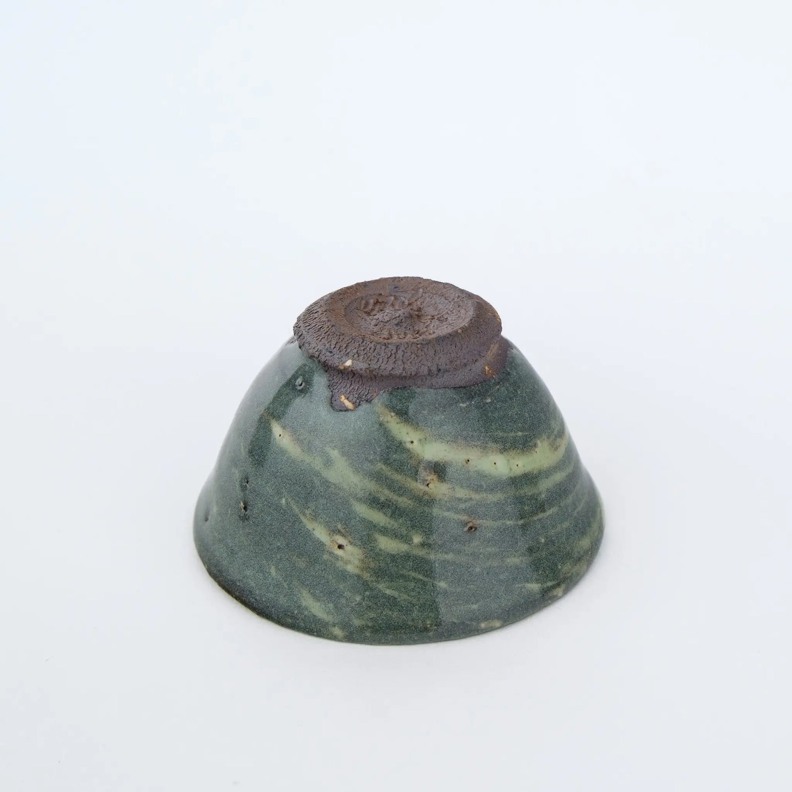 Ceramic teacup on a white background - underside view