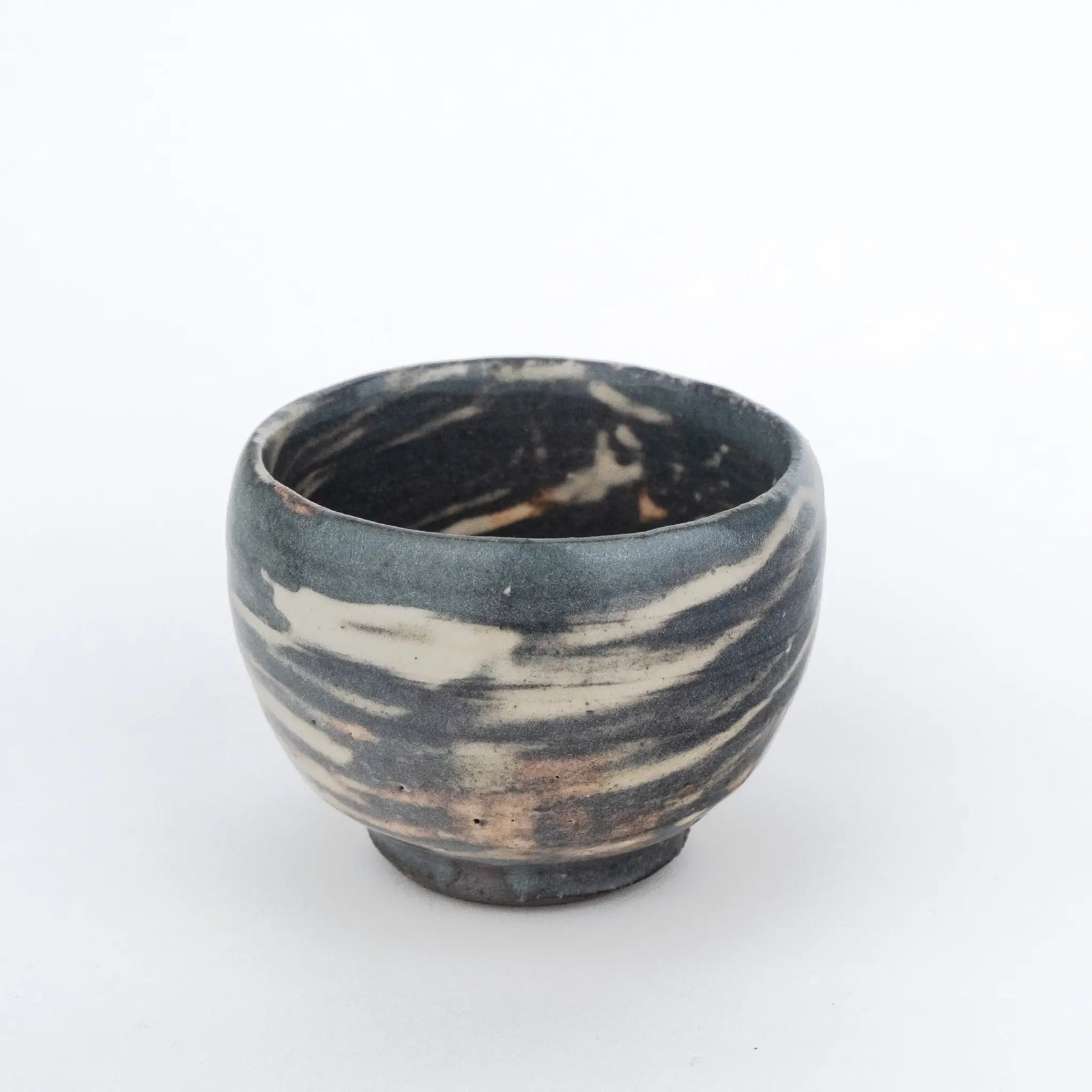 Grey handmade tea cup without a handle and with a white streaky glaze - with a bit of an inside view