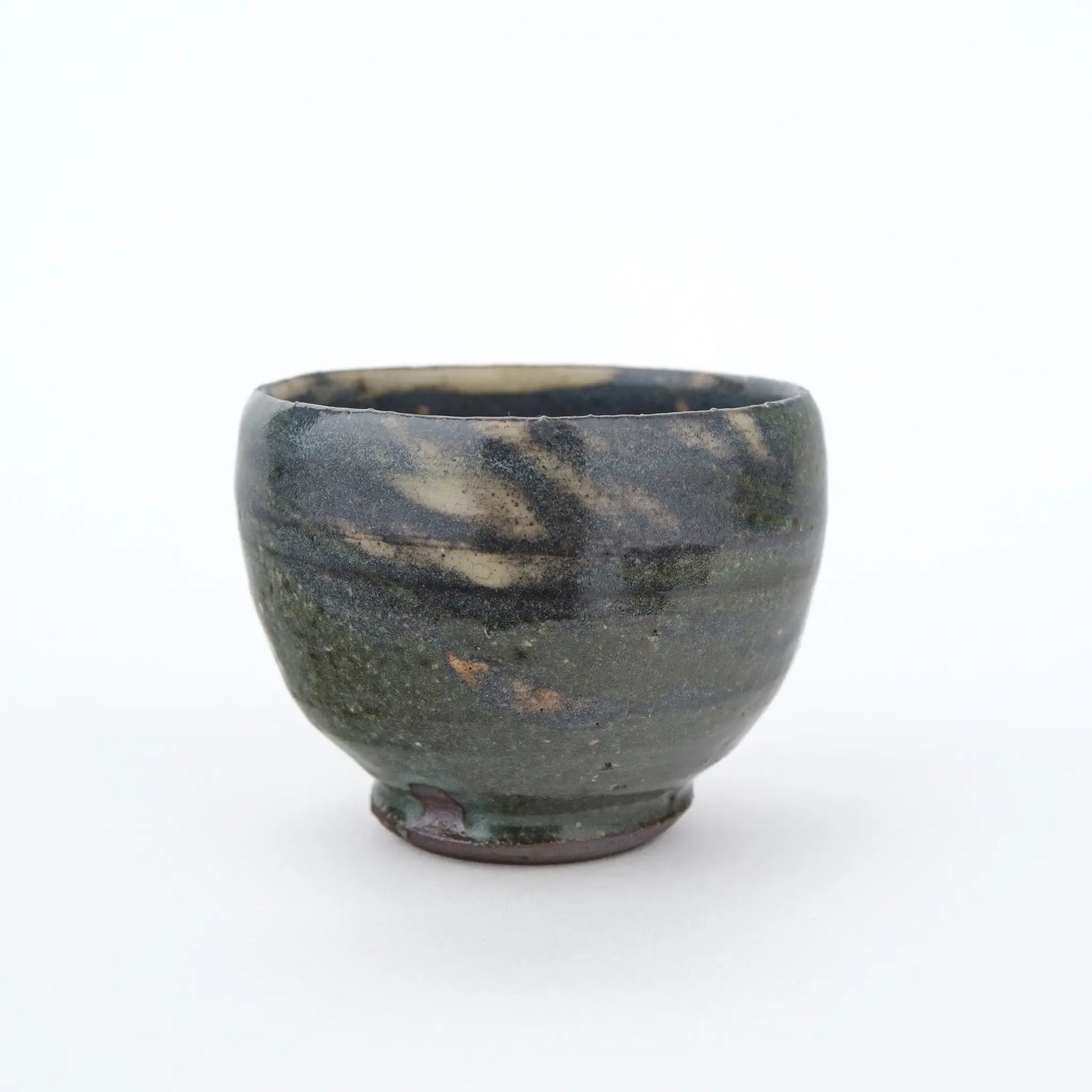 Ceramic cup with a unique glaze pattern on a white background