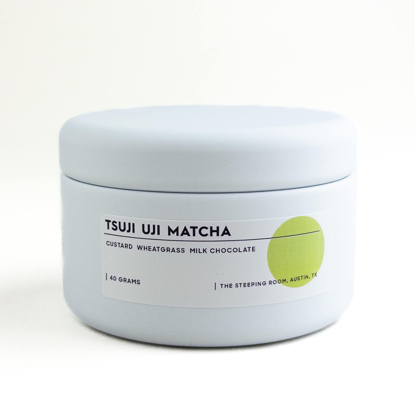Tsuji Uji Matcha container with white lid and label on a light gray background