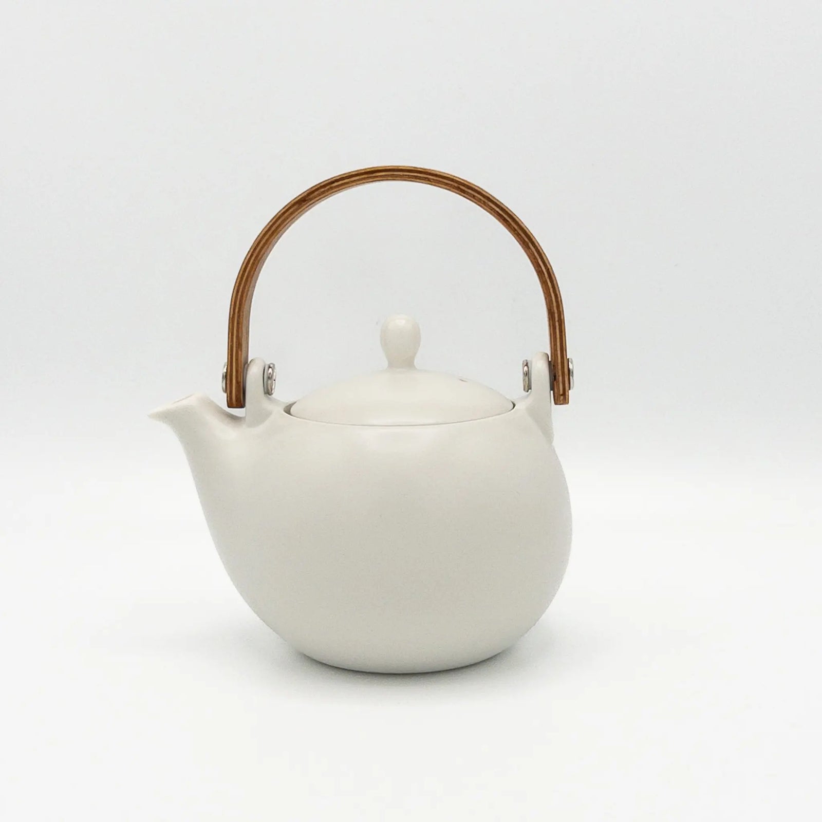 White teapot with a wooden handle on a white background