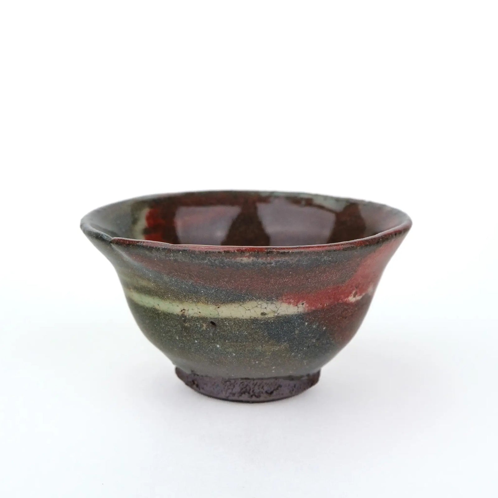 Mark Mohler gong fu cup #2C from a slightly raised angle showing a glossy dark red glaze inside and a pale band around the outside
