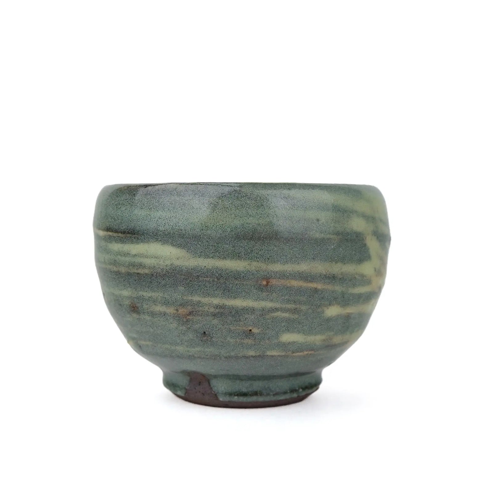 Mark Mohler handmade tea cup #B, 95 ml, side view of the rounded cup in a muted green glaze with pale streaks and an unglazed foot