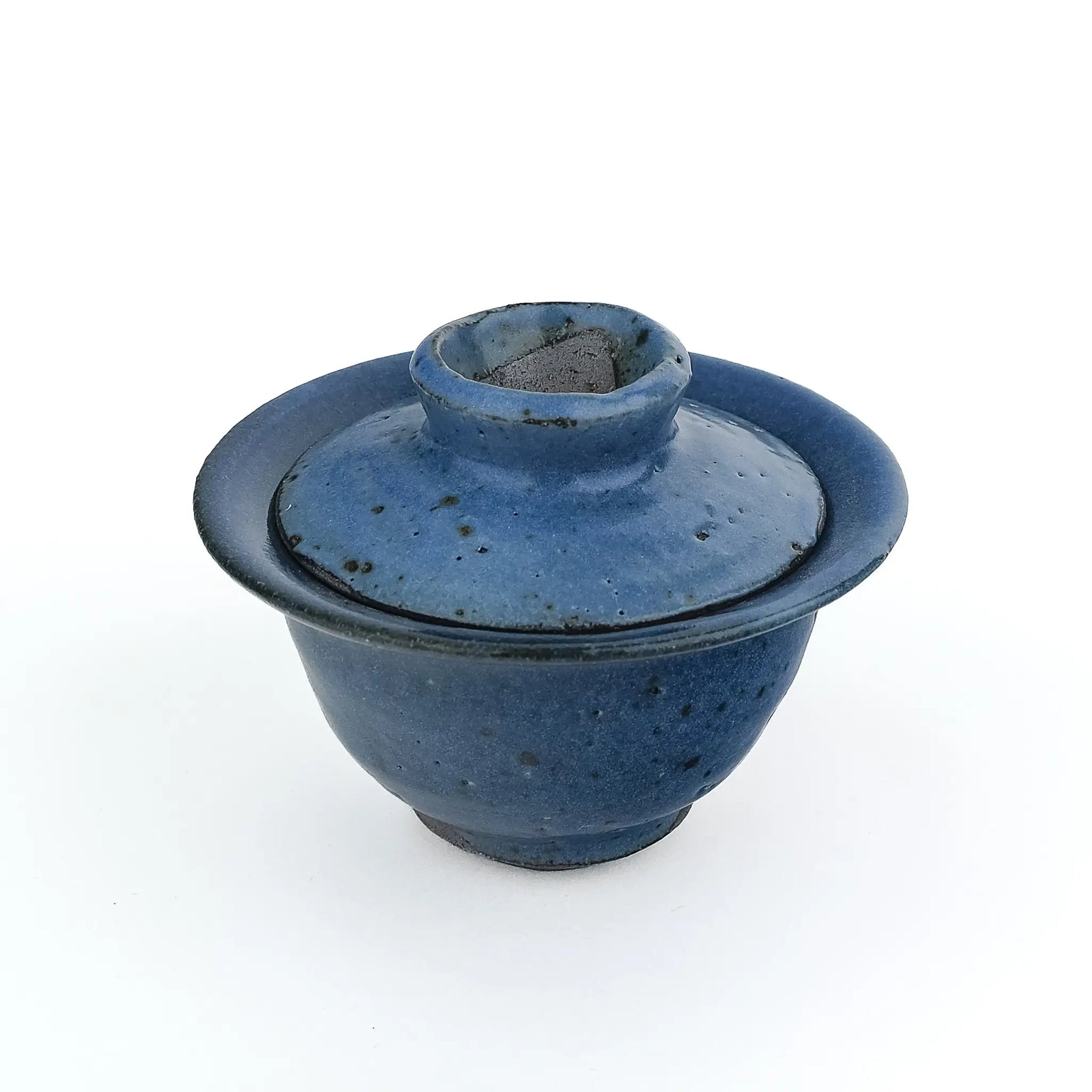 Mark Mohler handmade gaiwan #12 from a slightly raised angle with the lid in place, showing the knob and dark speckles in the blue glaze