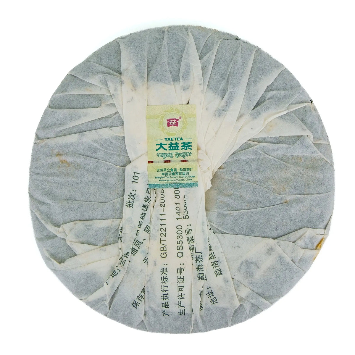 Back of the 2011 Dayi 7542 raw puerh cake, folded paper wrapper with a small Taetea label and the printed batch number 101
