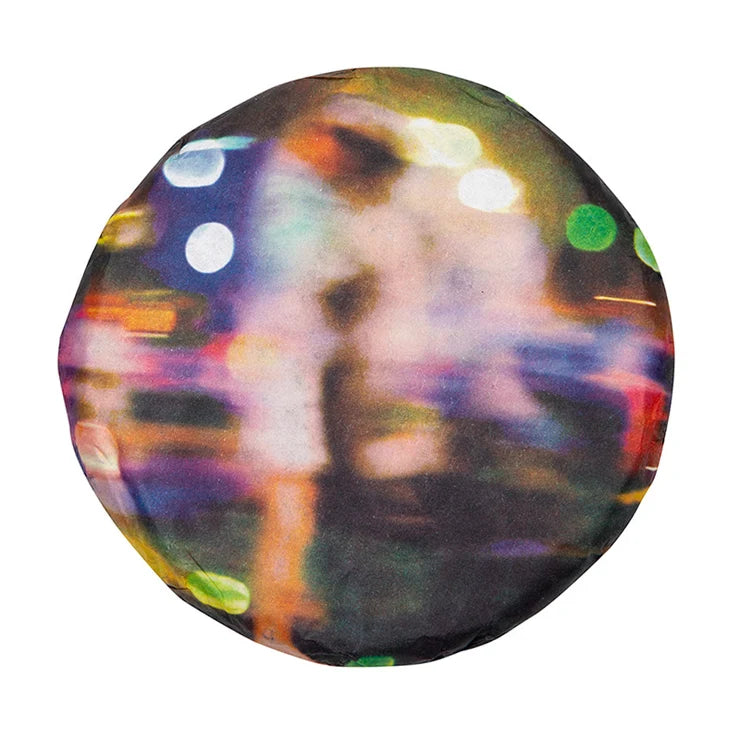 2022 White2Tea Valley ripe puerh cake in a wrapper printed with a blurred photo of a figure and colorful city lights