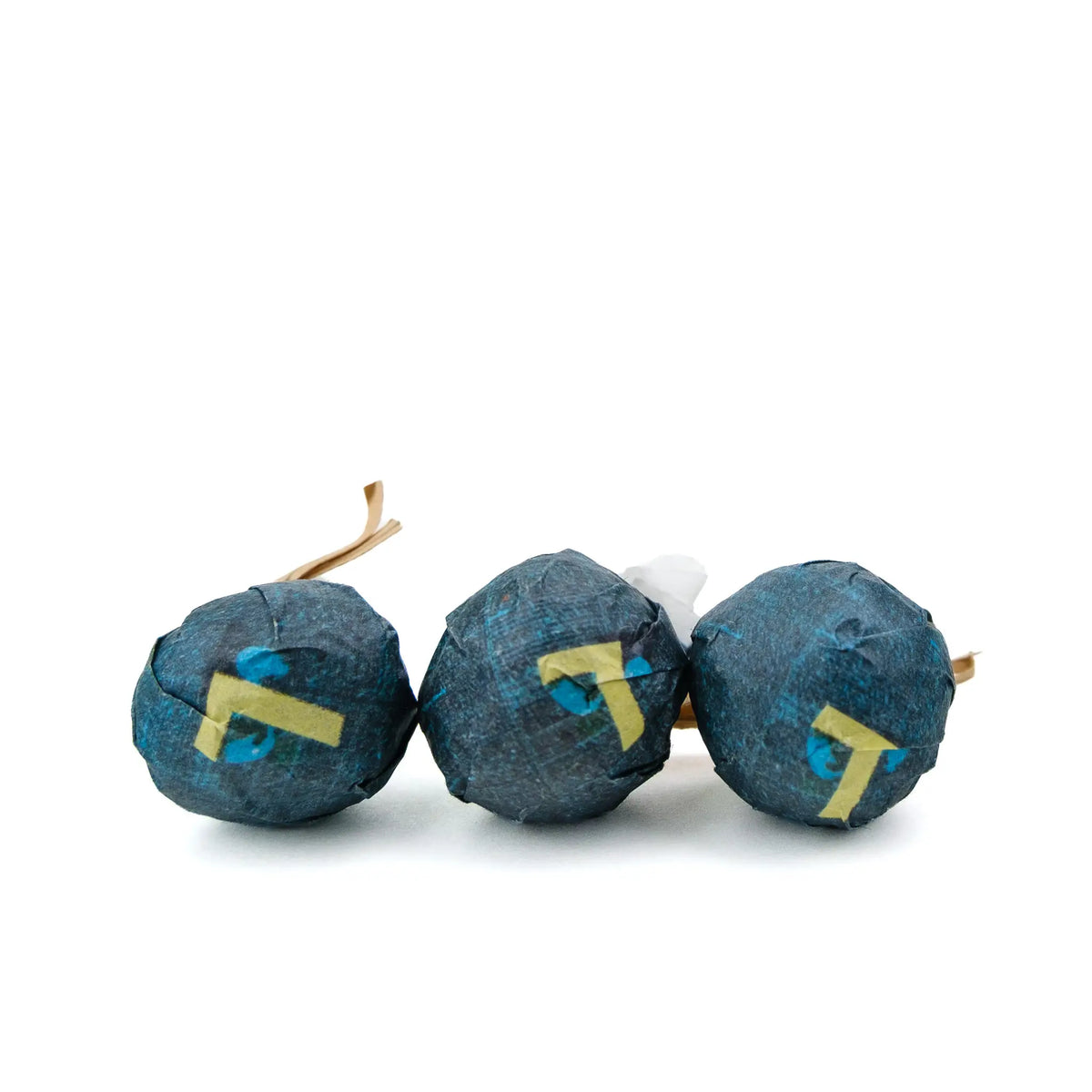 Three White2Tea Schedule White tea minis in dark blue paper wrappers marked with a yellow 7