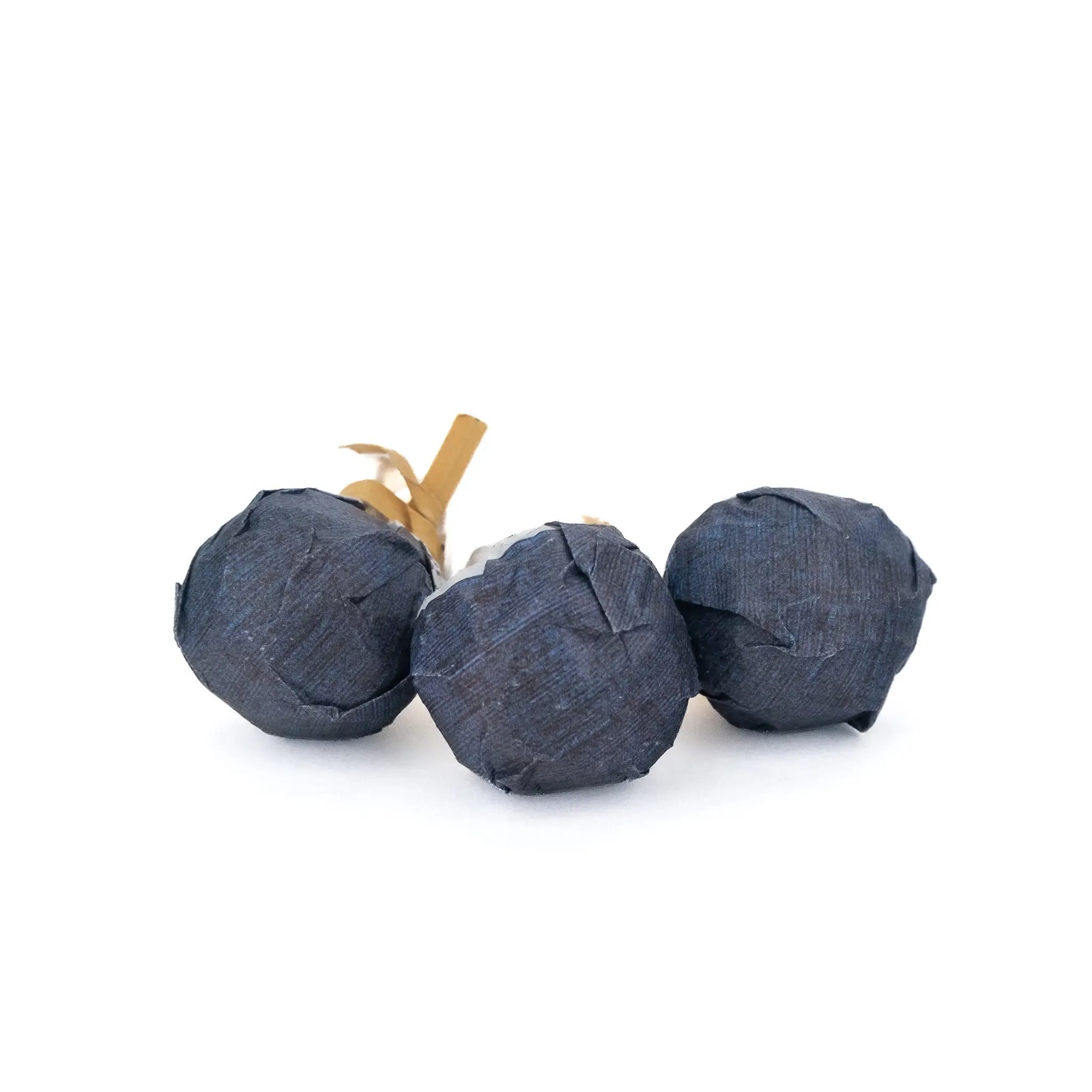 small, compressed balls of puerh tea wrapped with dark blue wrappers