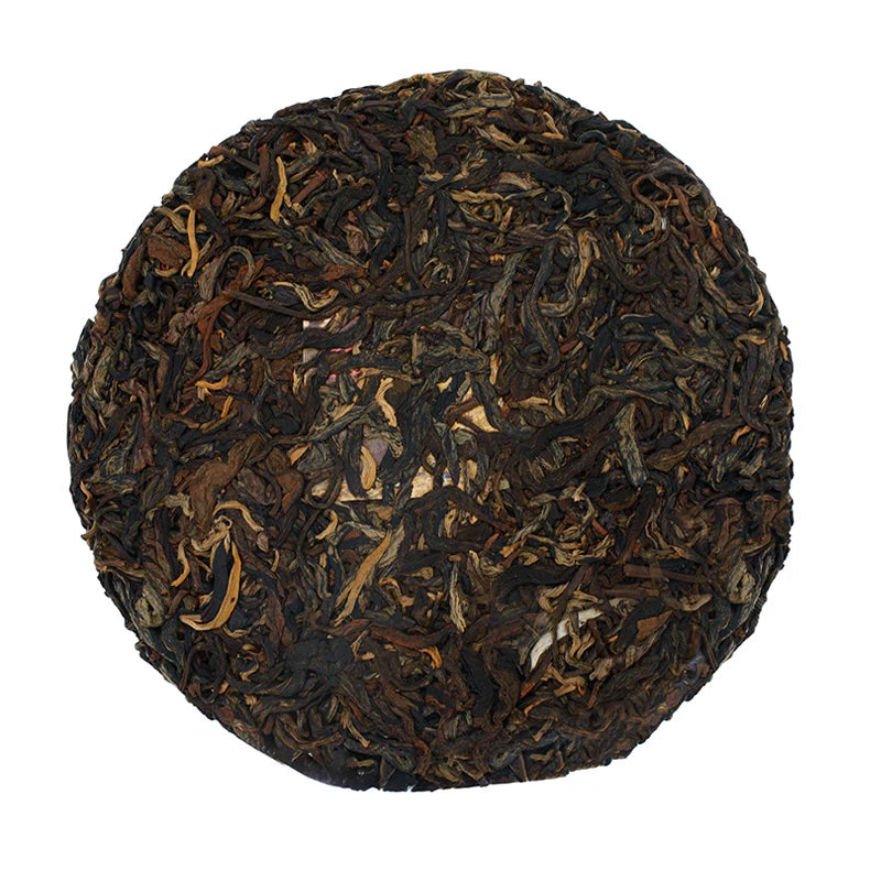 An unwrapped cake of 2026 White2Tea Swerve Charcoal Roasted Black Tea on a white background