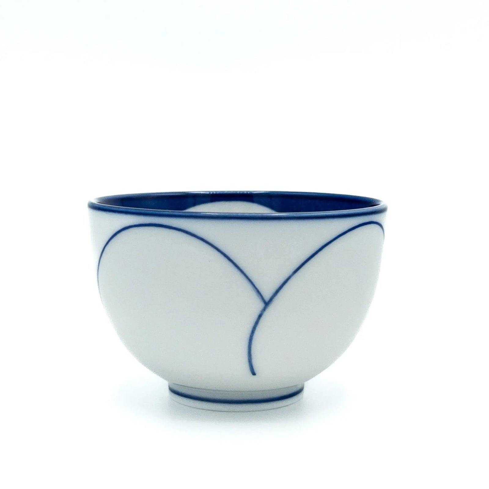 White ceramic teacup with blue decorative lines on a white background