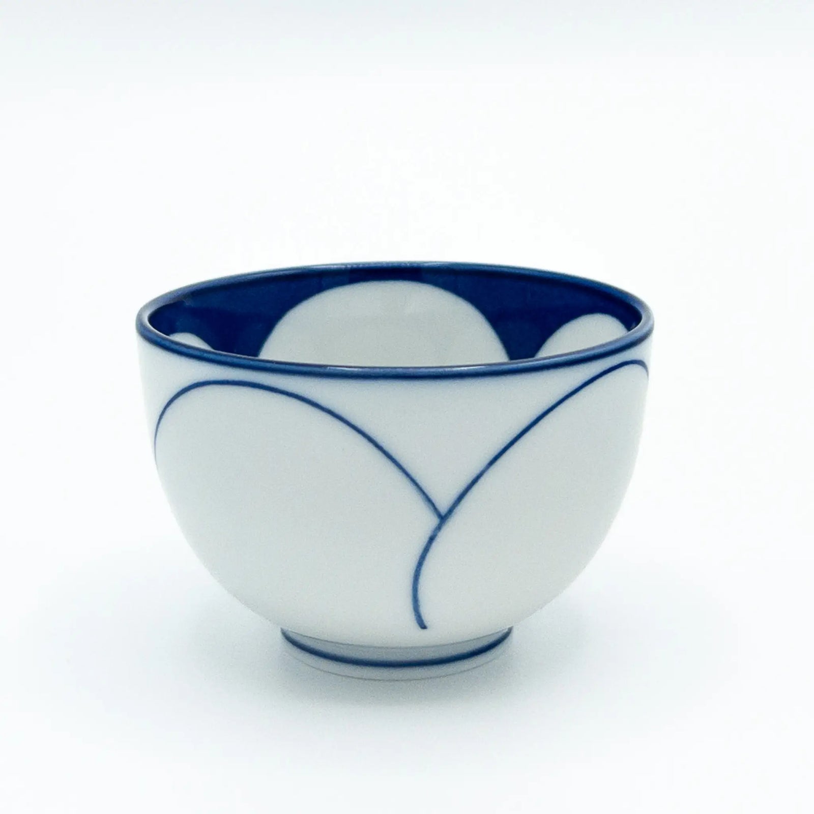 White ceramic Japanese teacup with blue decorative lines on a white background