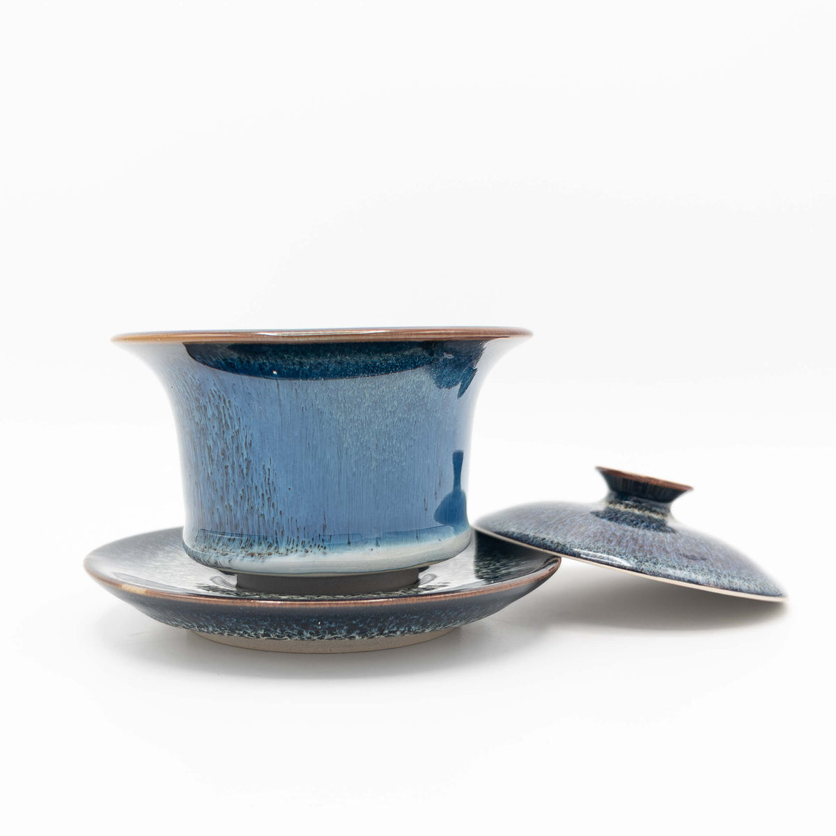 Galaxy Huaning Gaiwan with lid removed showing blue and purple glaze with crystalline pattern on saucer