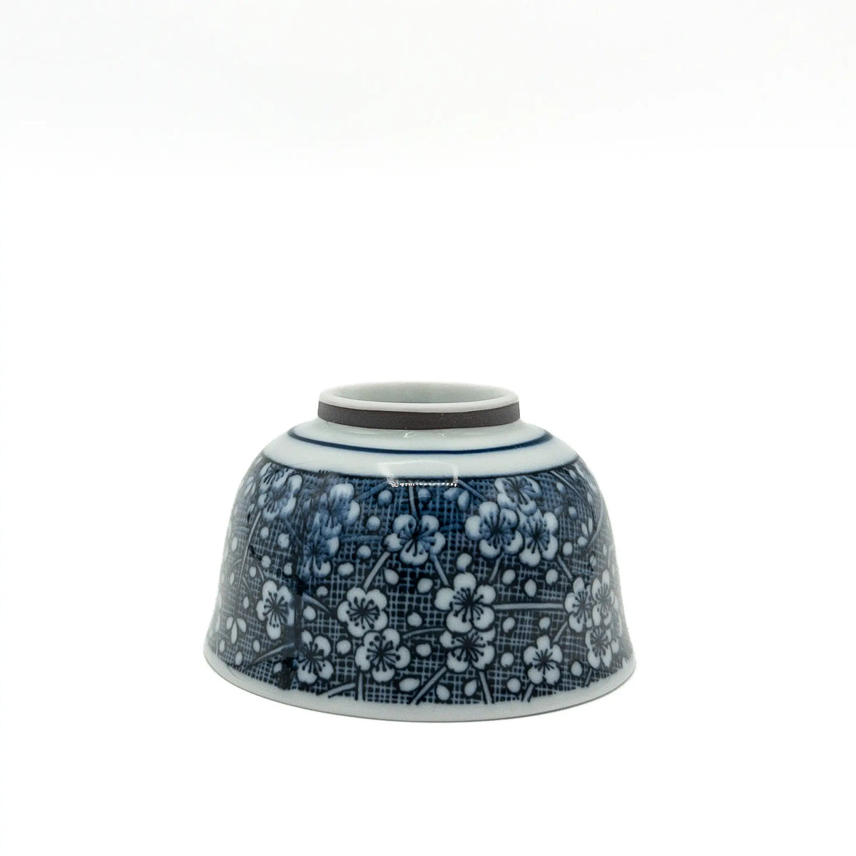 Porcelain Mino ware yunomi with white plum blossoms on a cobalt blue hatched ground - upside down view