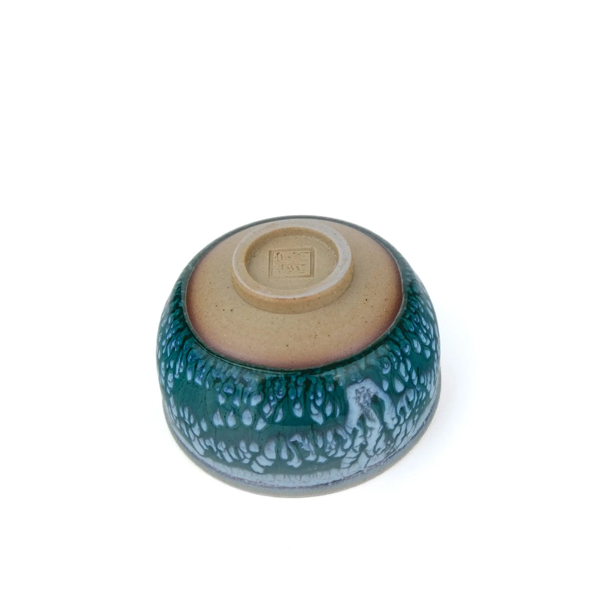 Huaning handmade cup #328 upside down, showing the unglazed base, foot ring, and stamped seal