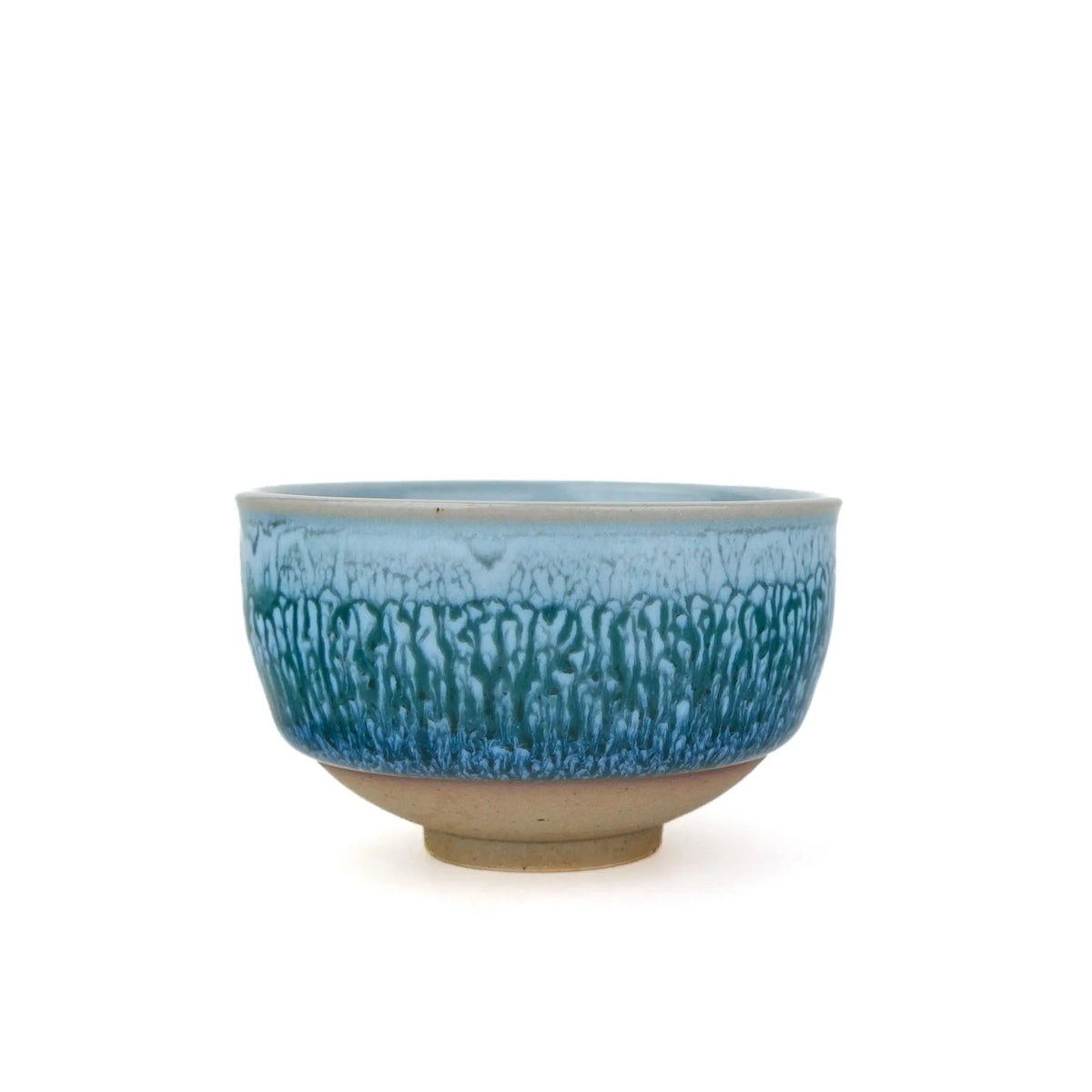 Huaning handmade cup #328 at eye level, streaked blue and green glaze above an unglazed clay foot