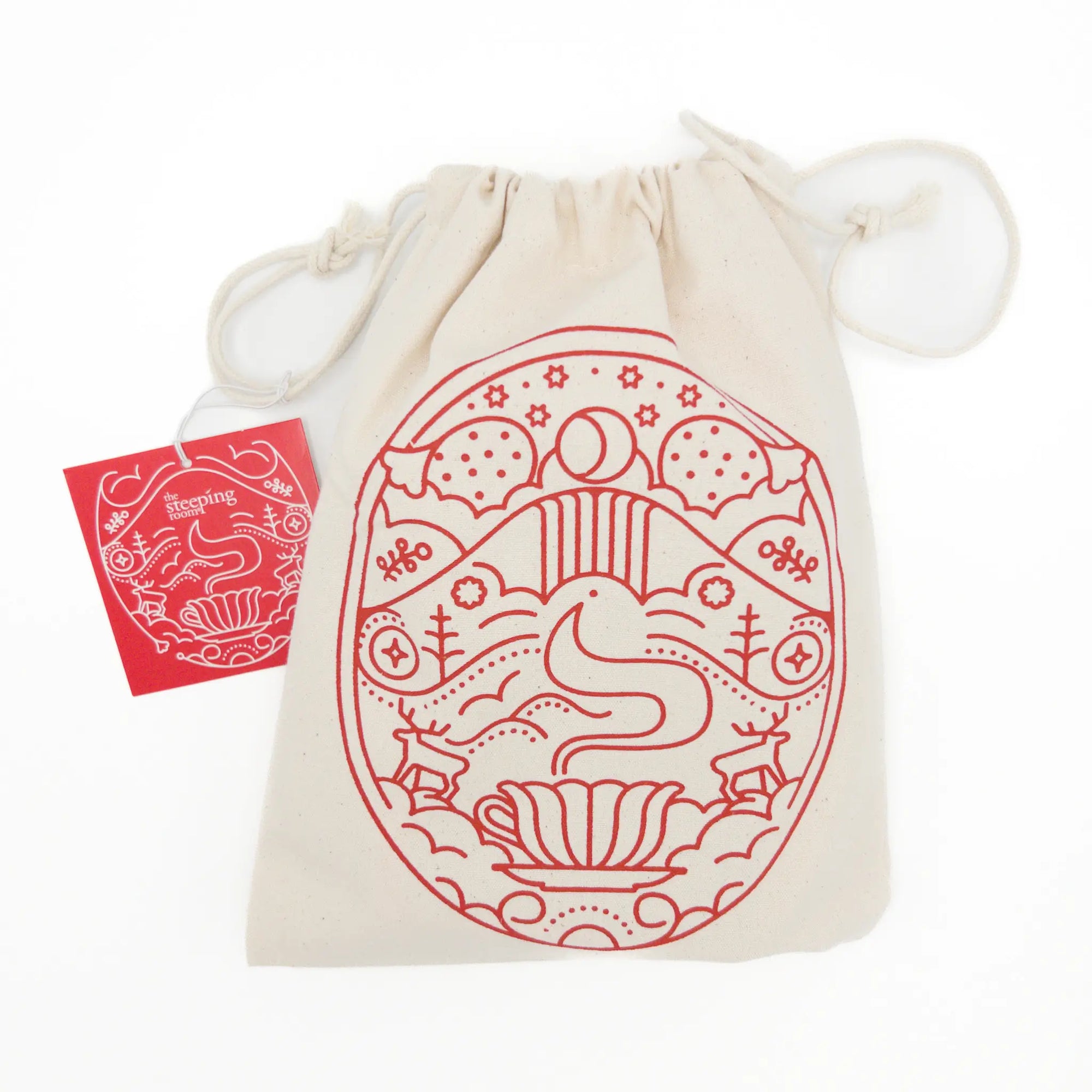 Beige drawstring bag with red decorative design and a small red card on a white background - Holiday Tea Trio Gift Set