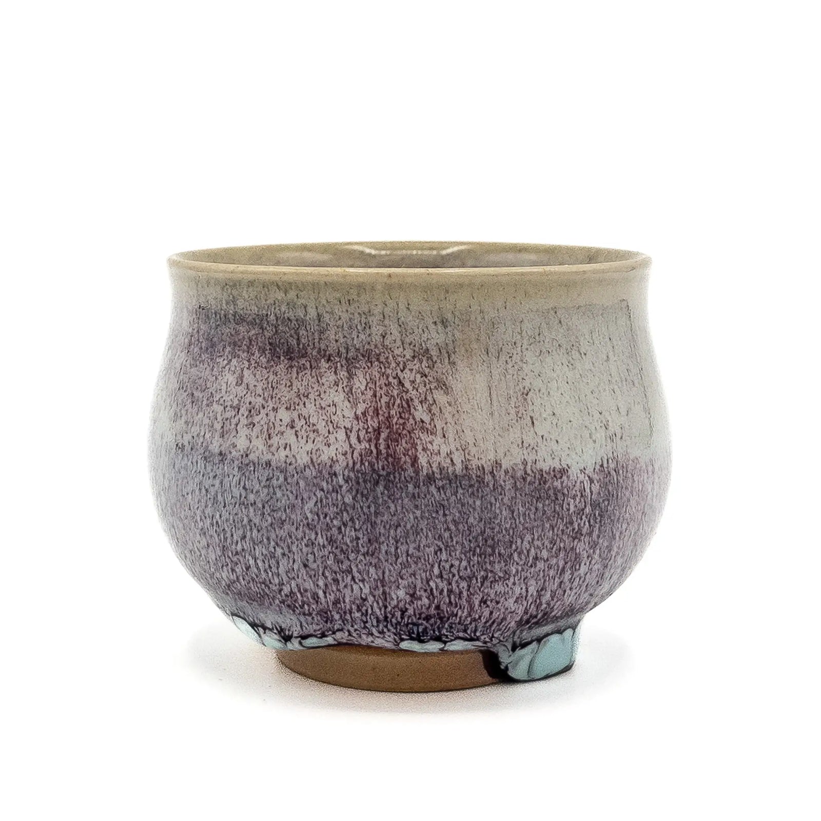 Ceramic cup with speckled glaze on a white background