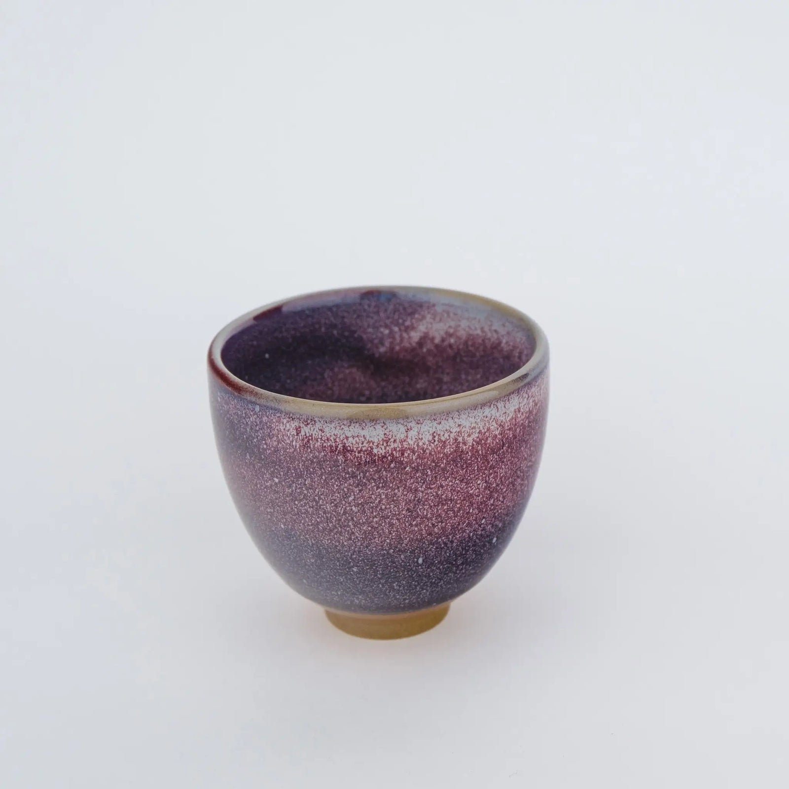 Purple ceramic cup on a white background