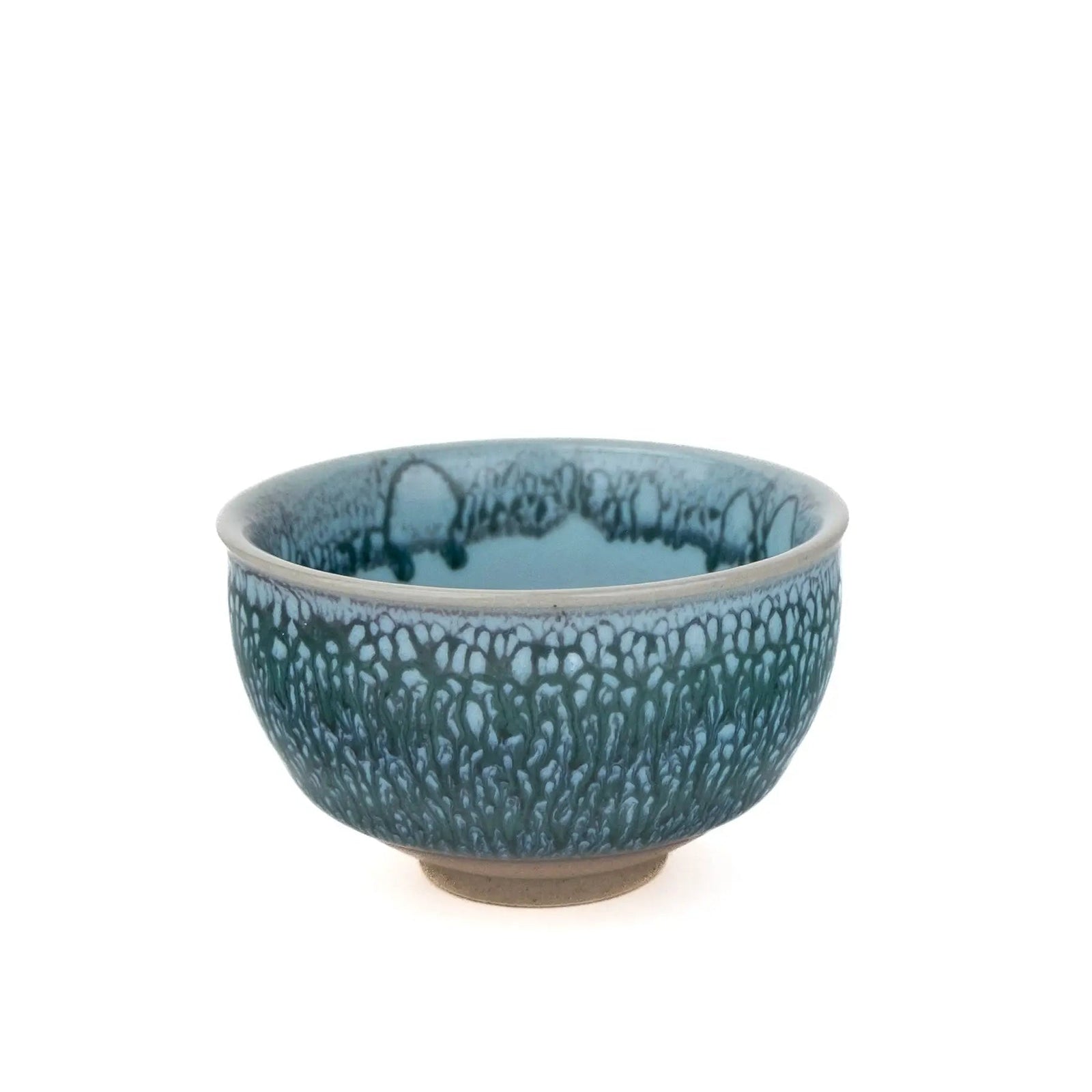A ceramic tea cup with a textured, mottled blue and green glaze, photographed against a solid white background.