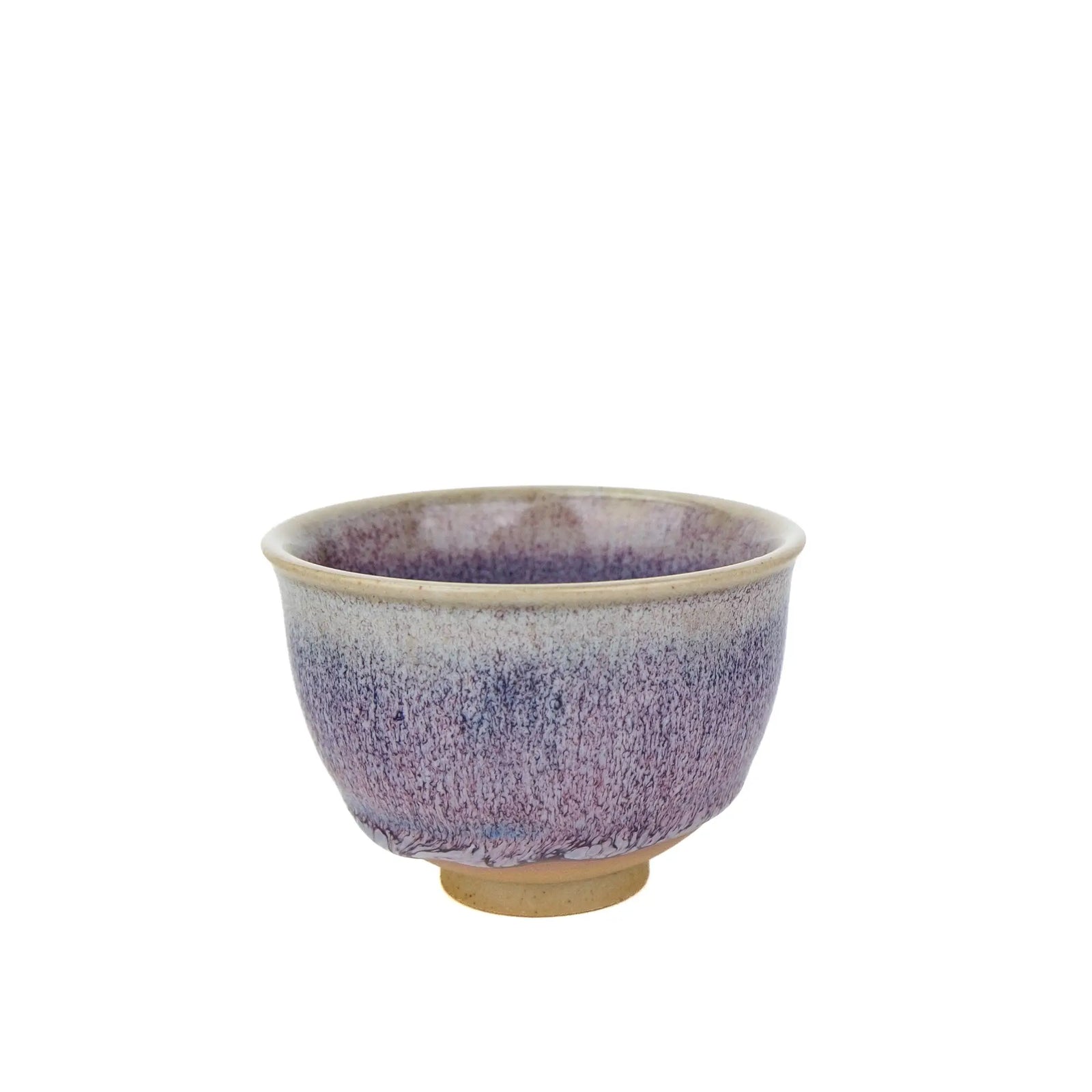A ceramic Huaning handmade teacup with a purple speckled glaze, featuring a natural beige clay foot and rim, set against a plain white background.