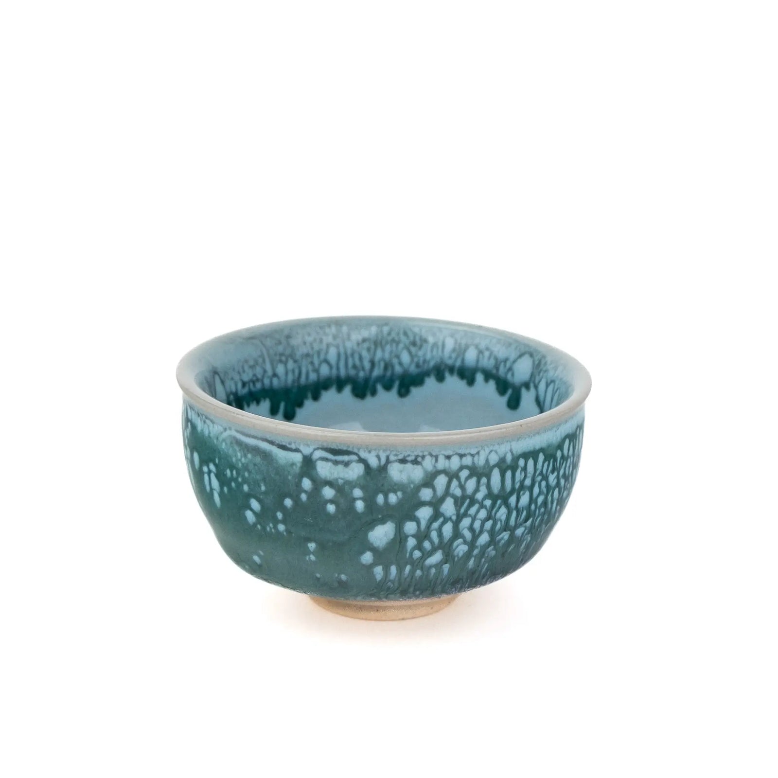 A ceramic tea cup with a speckled teal and blue glaze, photographed against a solid white background.