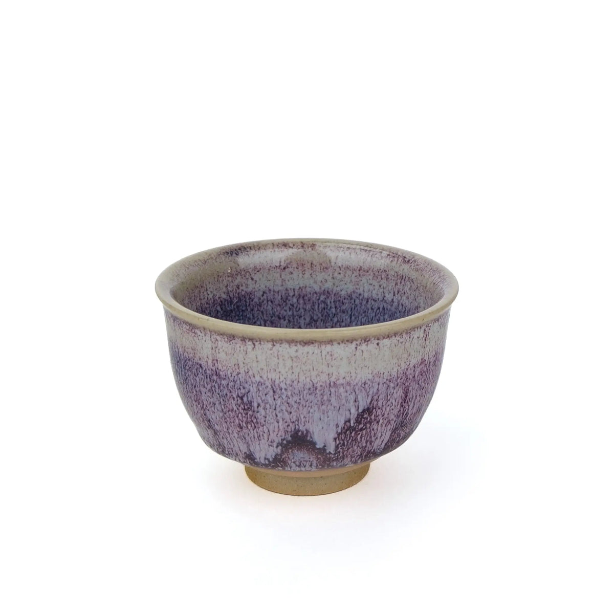 A ceramic tea handmade teacup with a purple and white glaze pattern and a natural beige clay base, shown against a plain white background.
