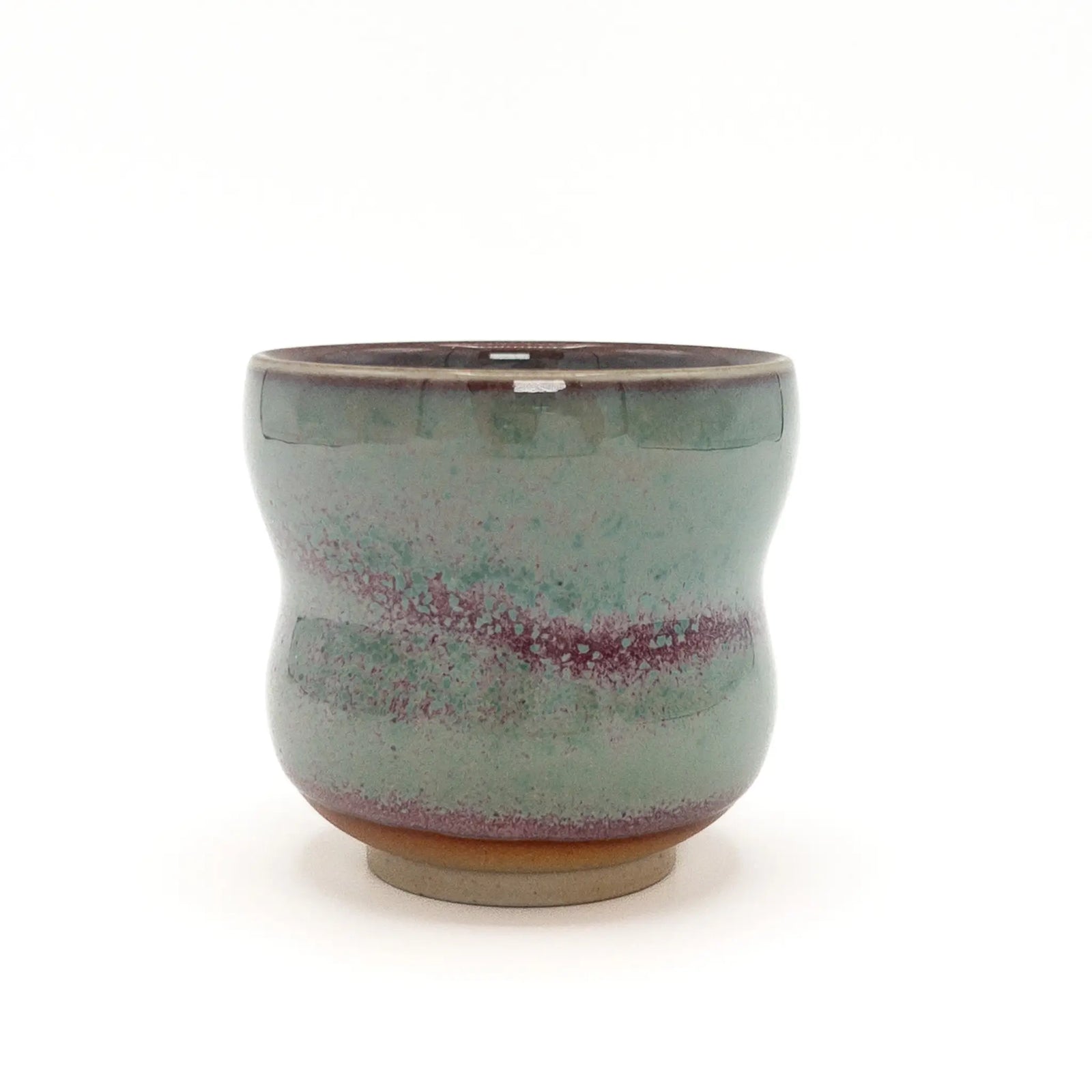 Ceramic cup with a speckled design on a white background
