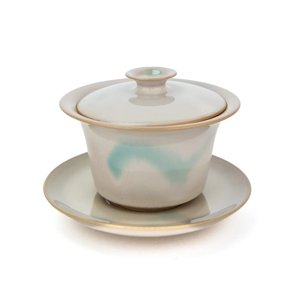A slightly overhead view of a Huaning pottery handmade gaiwan with a white glaze and a little bit of blue on the body.
