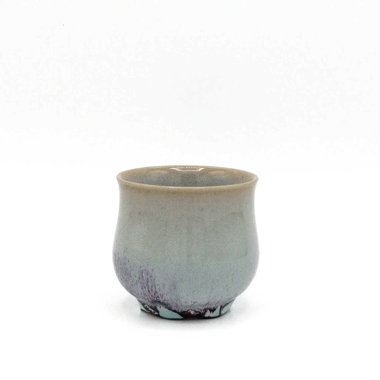 Ceramic cup with a speckled finish on a white background