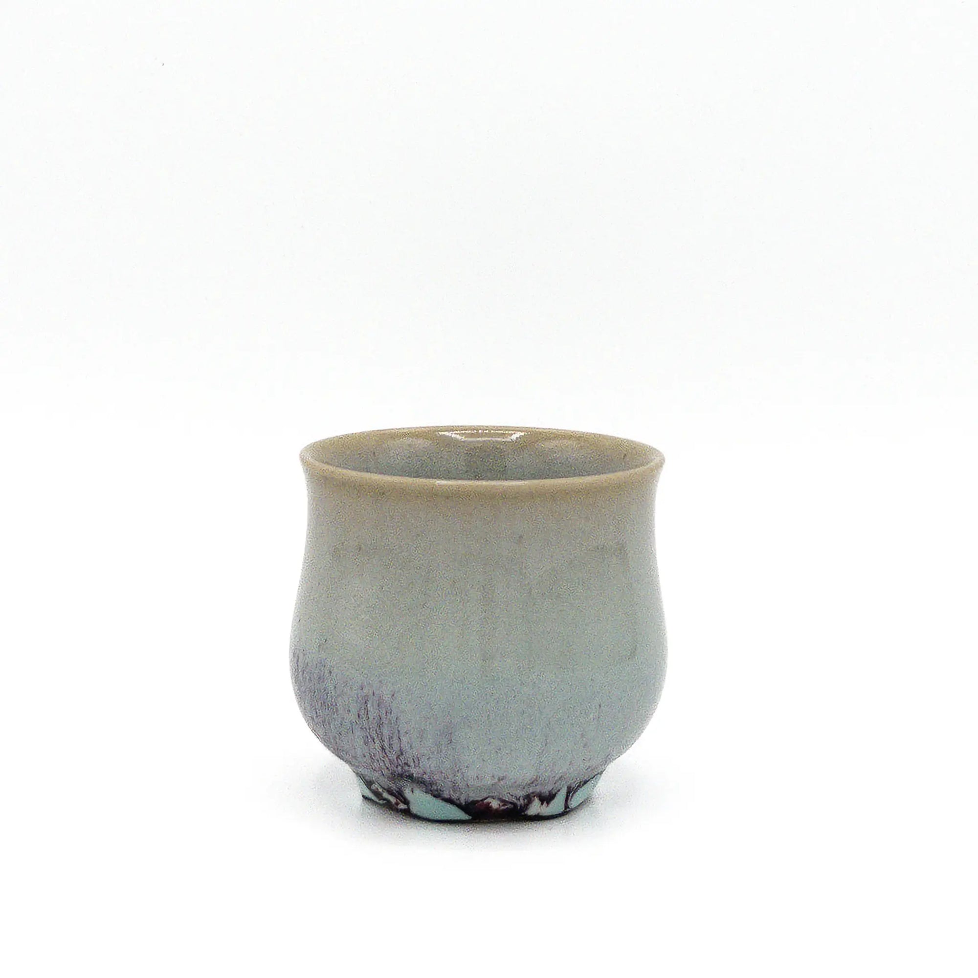 Ceramic cup with a speckled finish on a white background