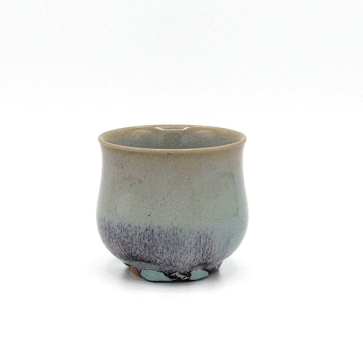 Ceramic cup with speckled design on a white background