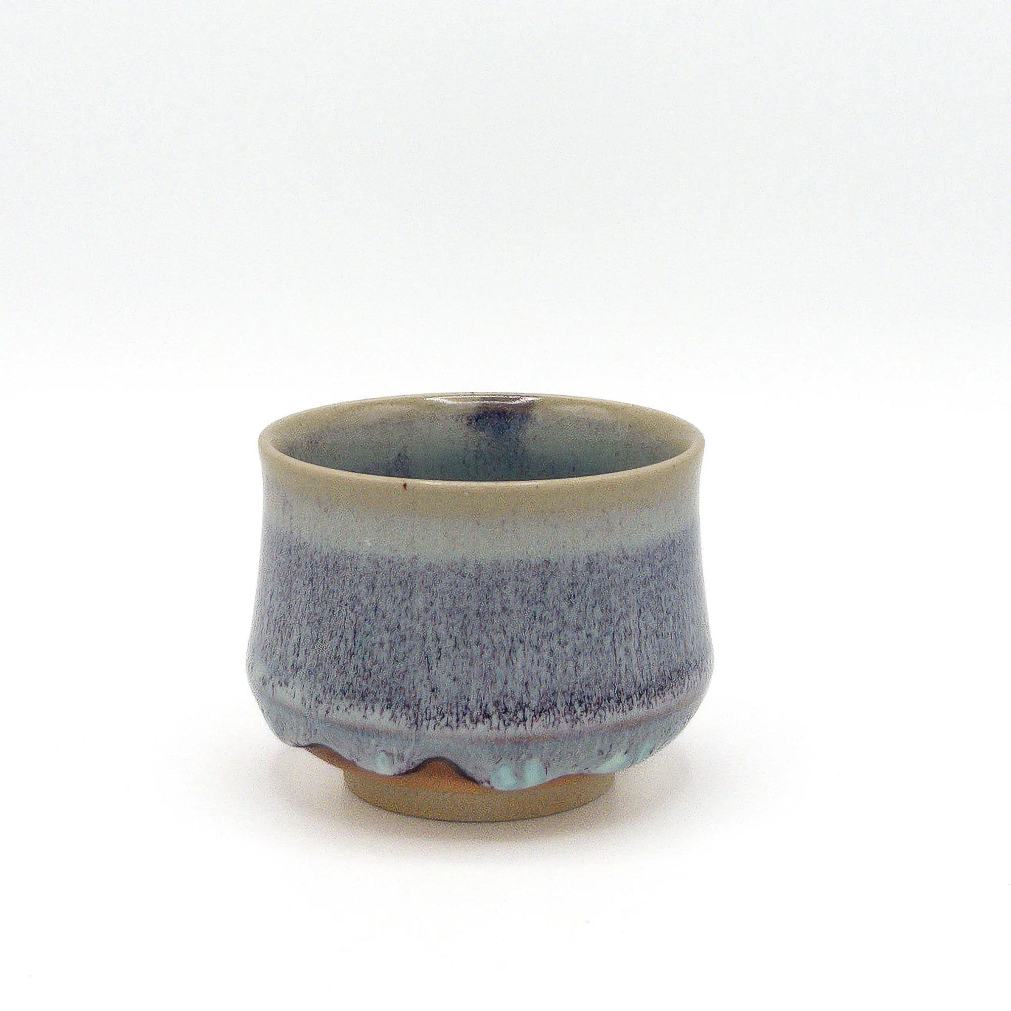 Ceramic cup with blue and gray speckled design on a white background