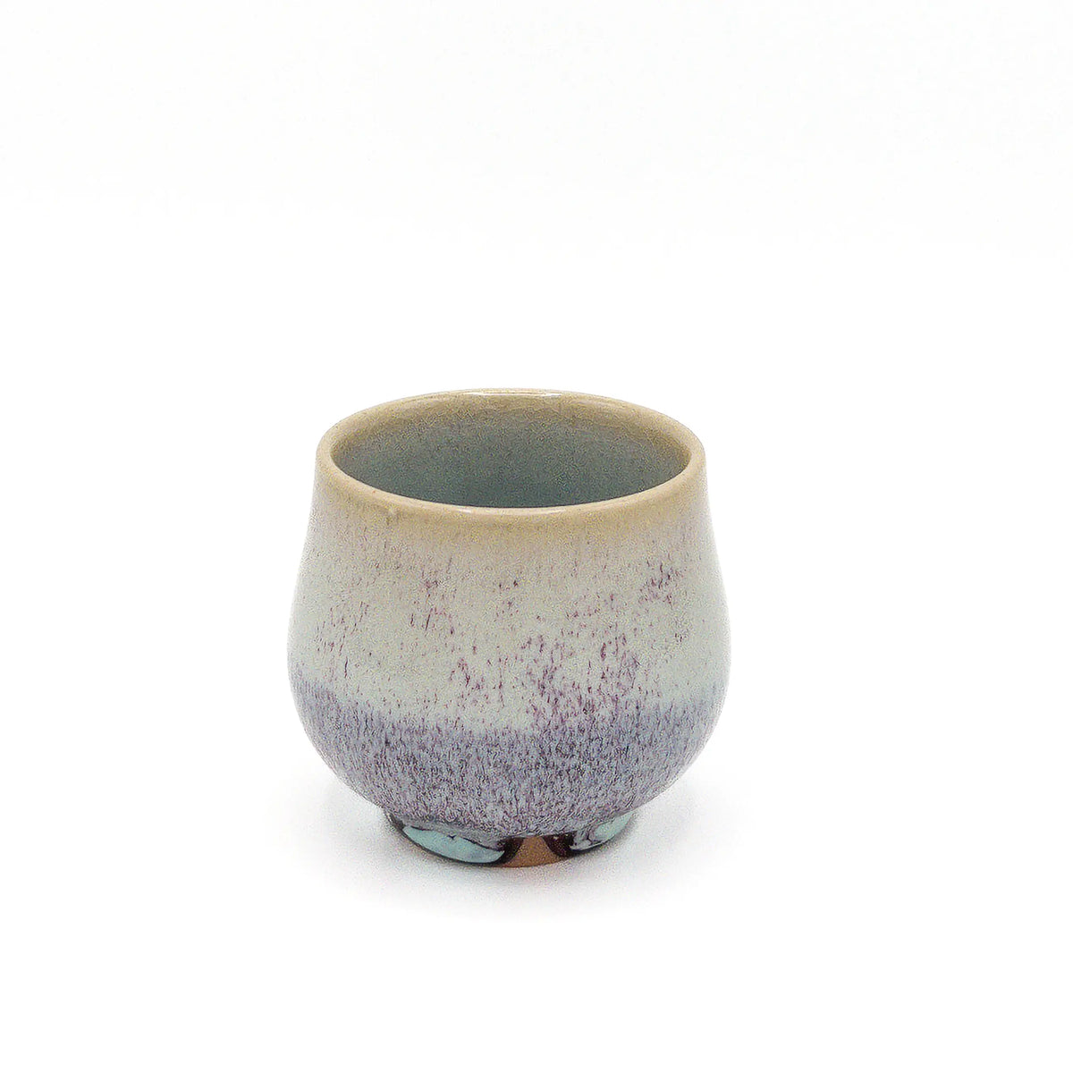 Ceramic cup with speckled design on a white background