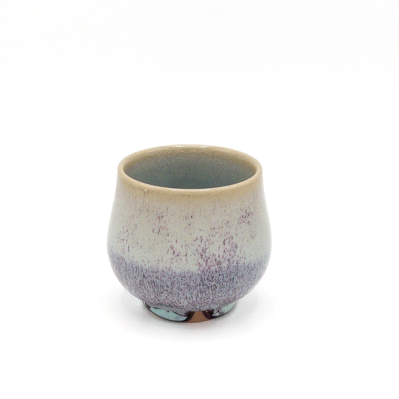 Ceramic cup with speckled design on a white background