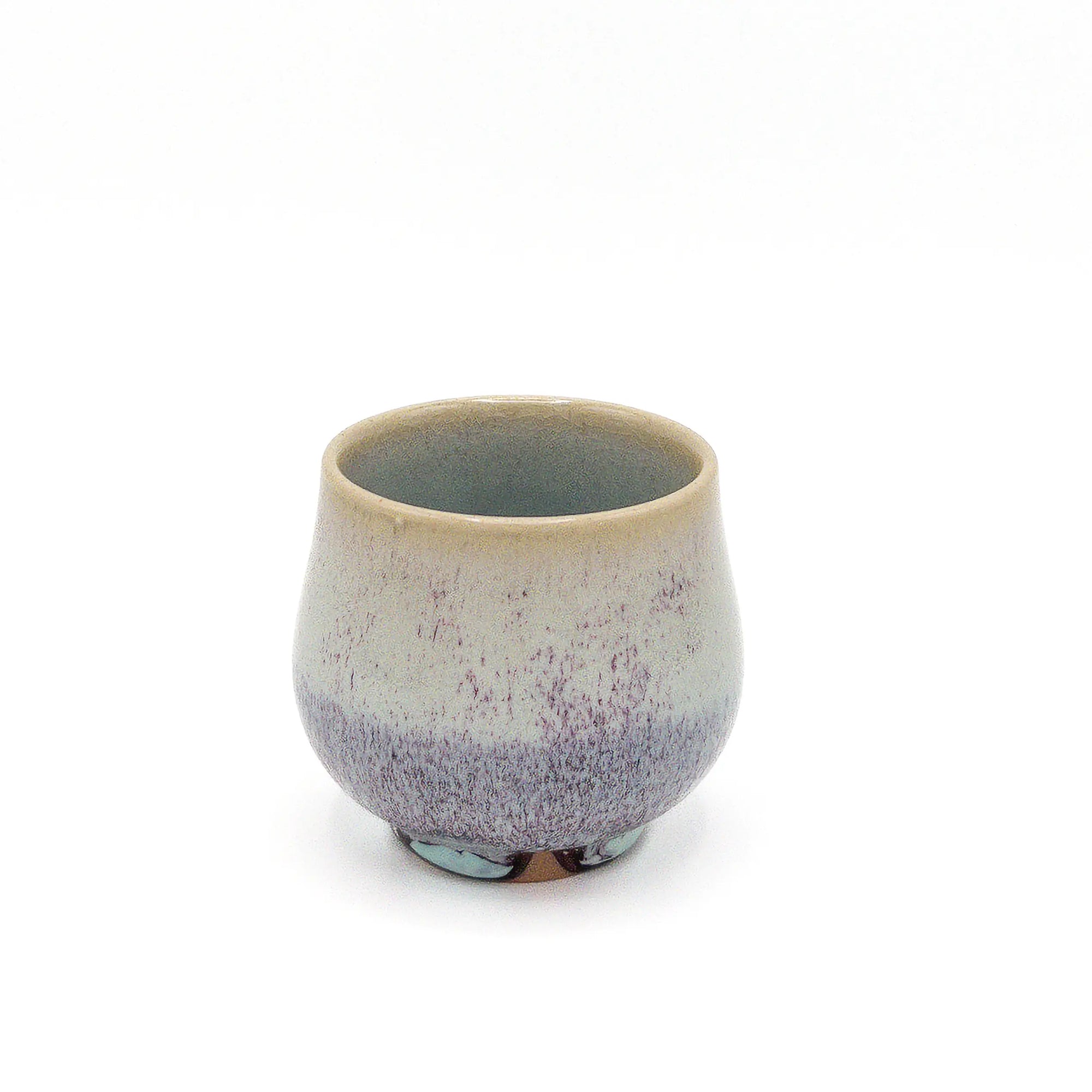 Ceramic cup with speckled design on a white background