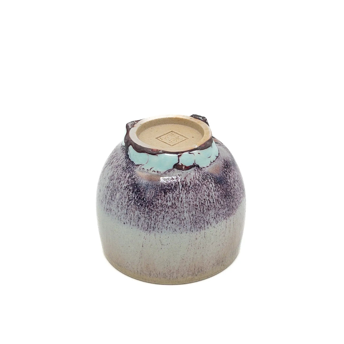 Ceramic cup with speckled design on a white background