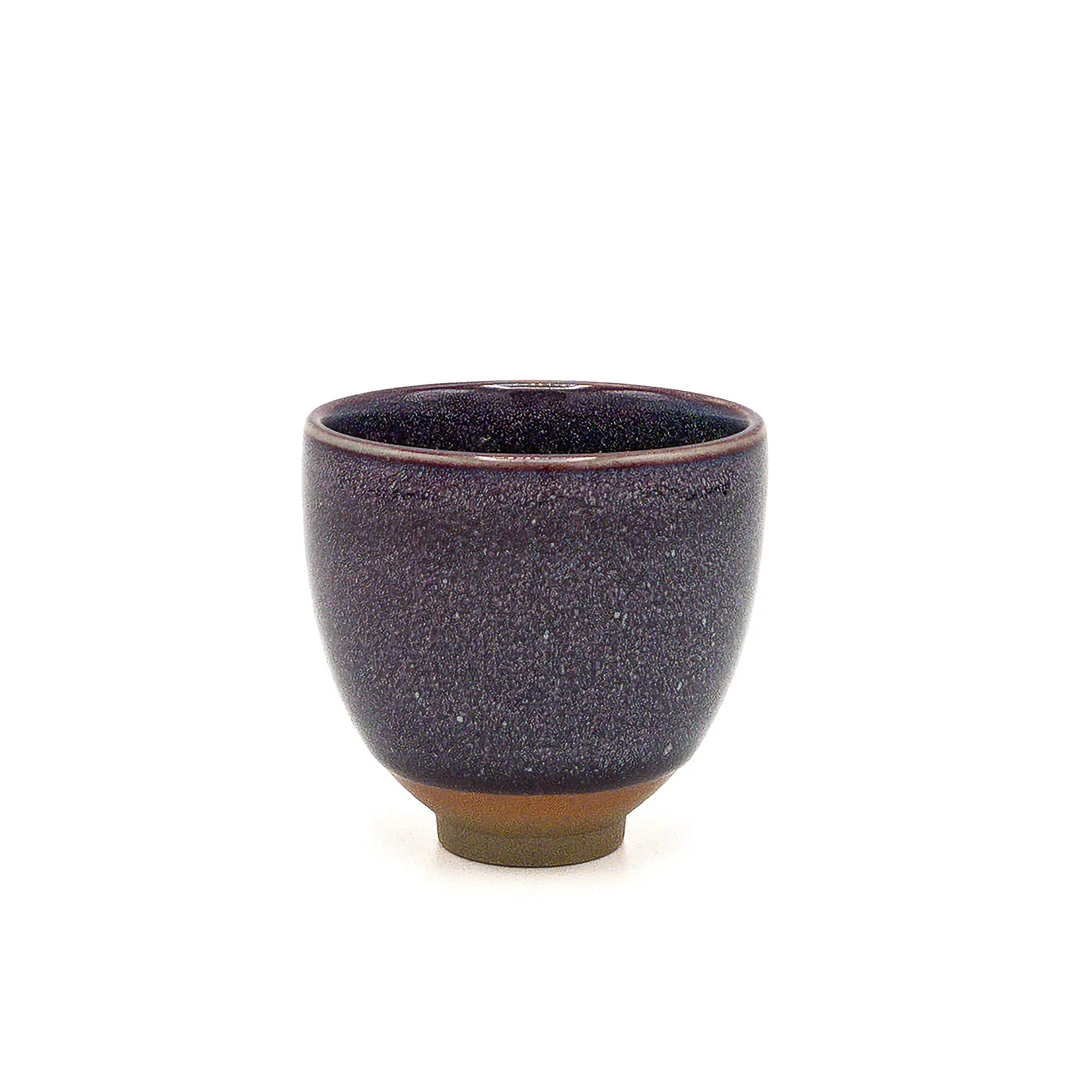 Dark speckled ceramic cup on a white background