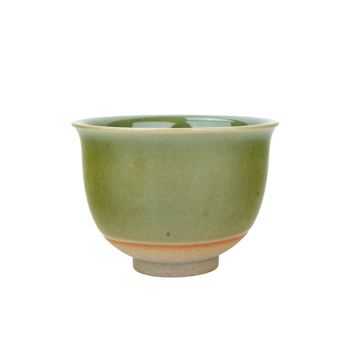 Huaning handmade cup #333 with a flared rim and green glaze, a warm orange band just above the unglazed clay foot