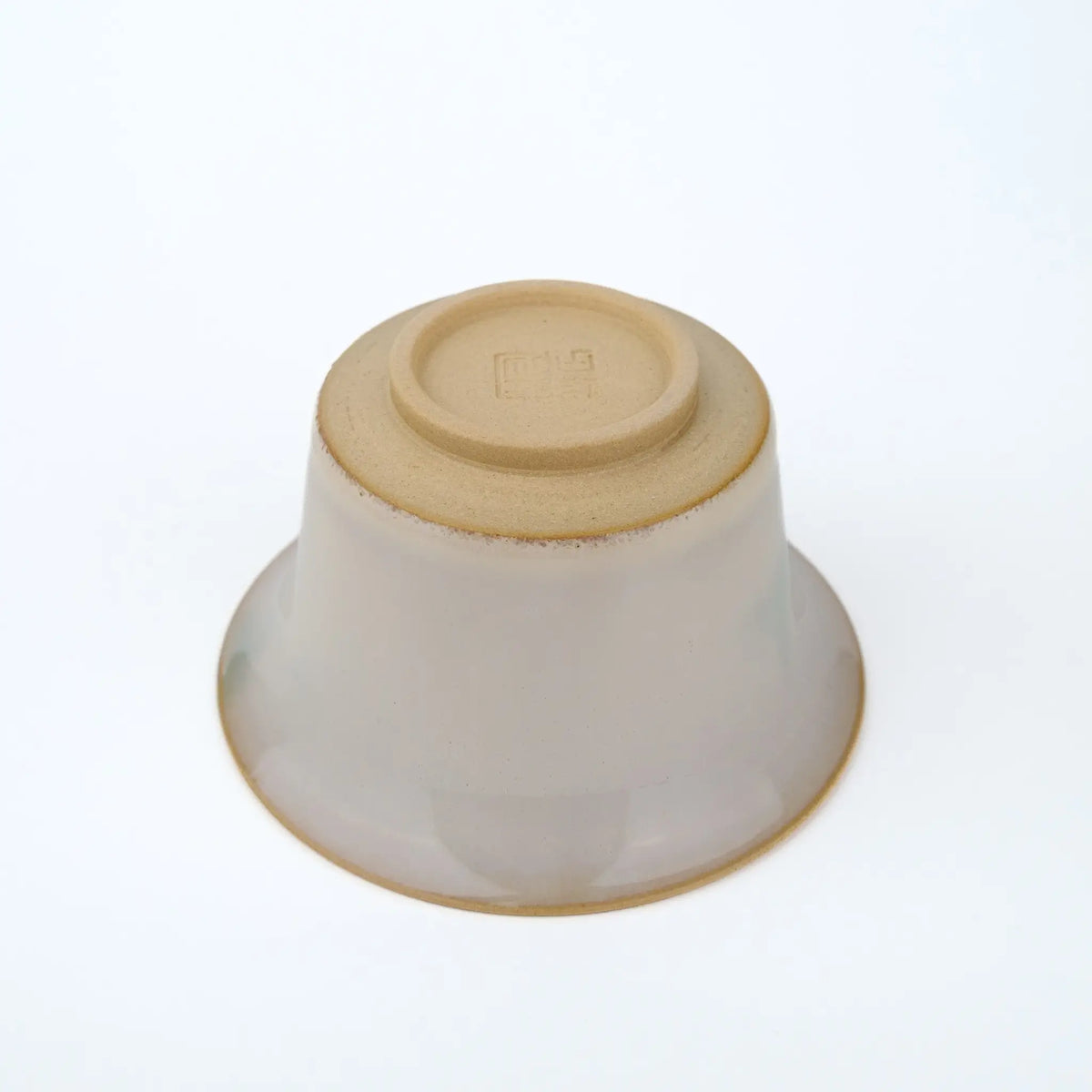 Huaning gaiwan #401 bowl upside down, showing the unglazed base, foot ring, and stamped seal